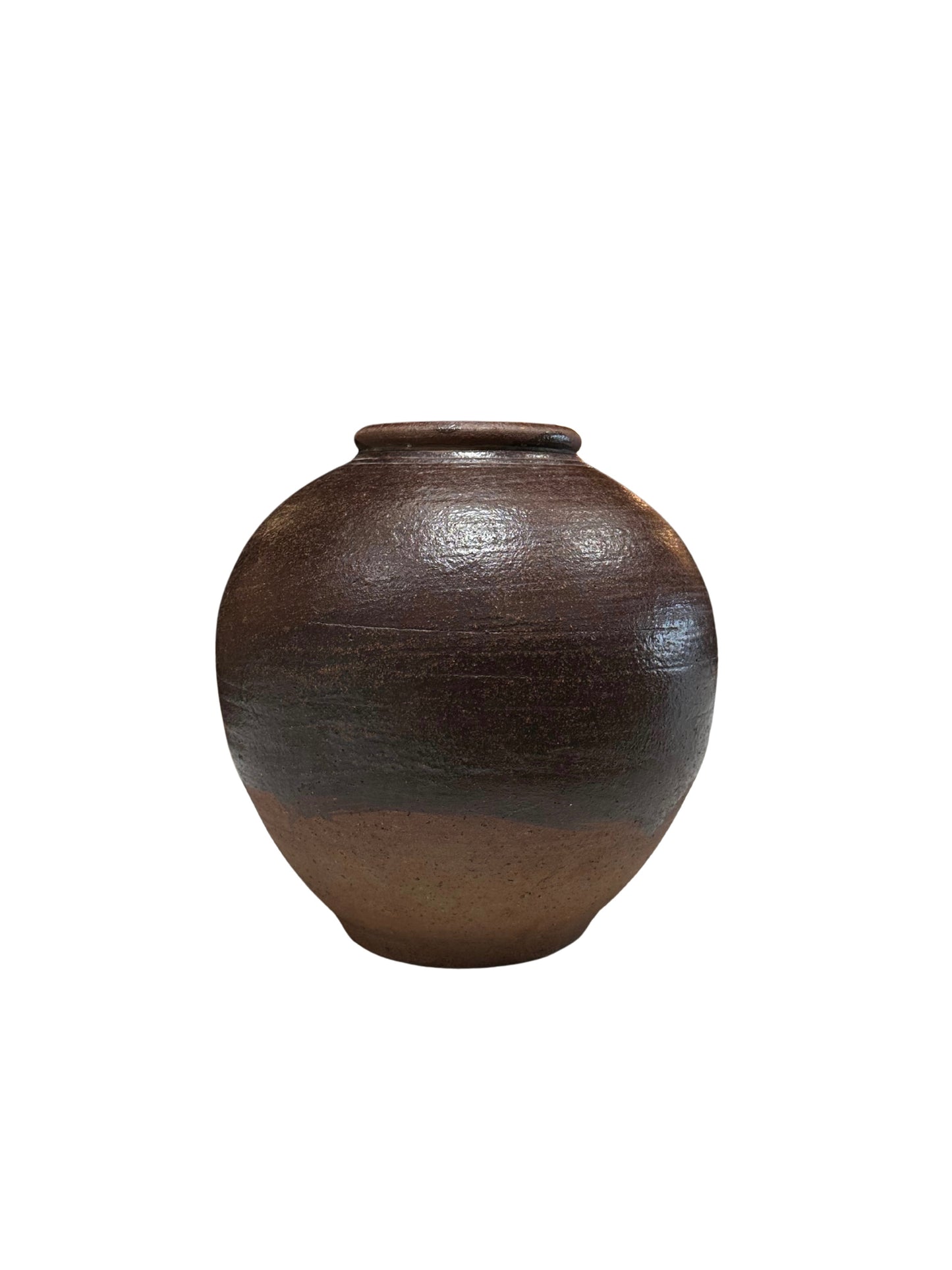 The Rustic Ceramic Vessel is a round, brown piece with a small opening and a smooth, glossy finish, displayed against a plain white background.