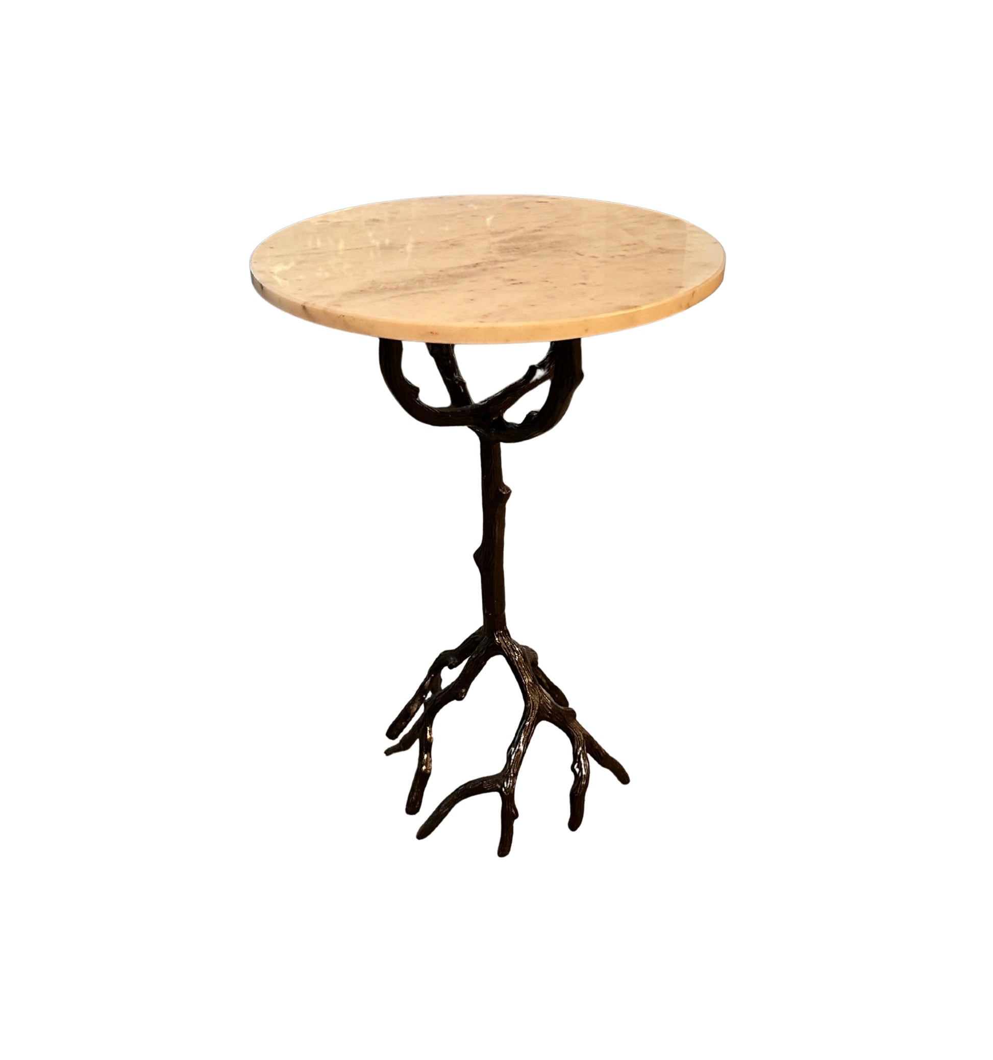The Iron and Marble Side Table features a small round marble top and a vintage iron base resembling tree branches and roots, set against a white background.
