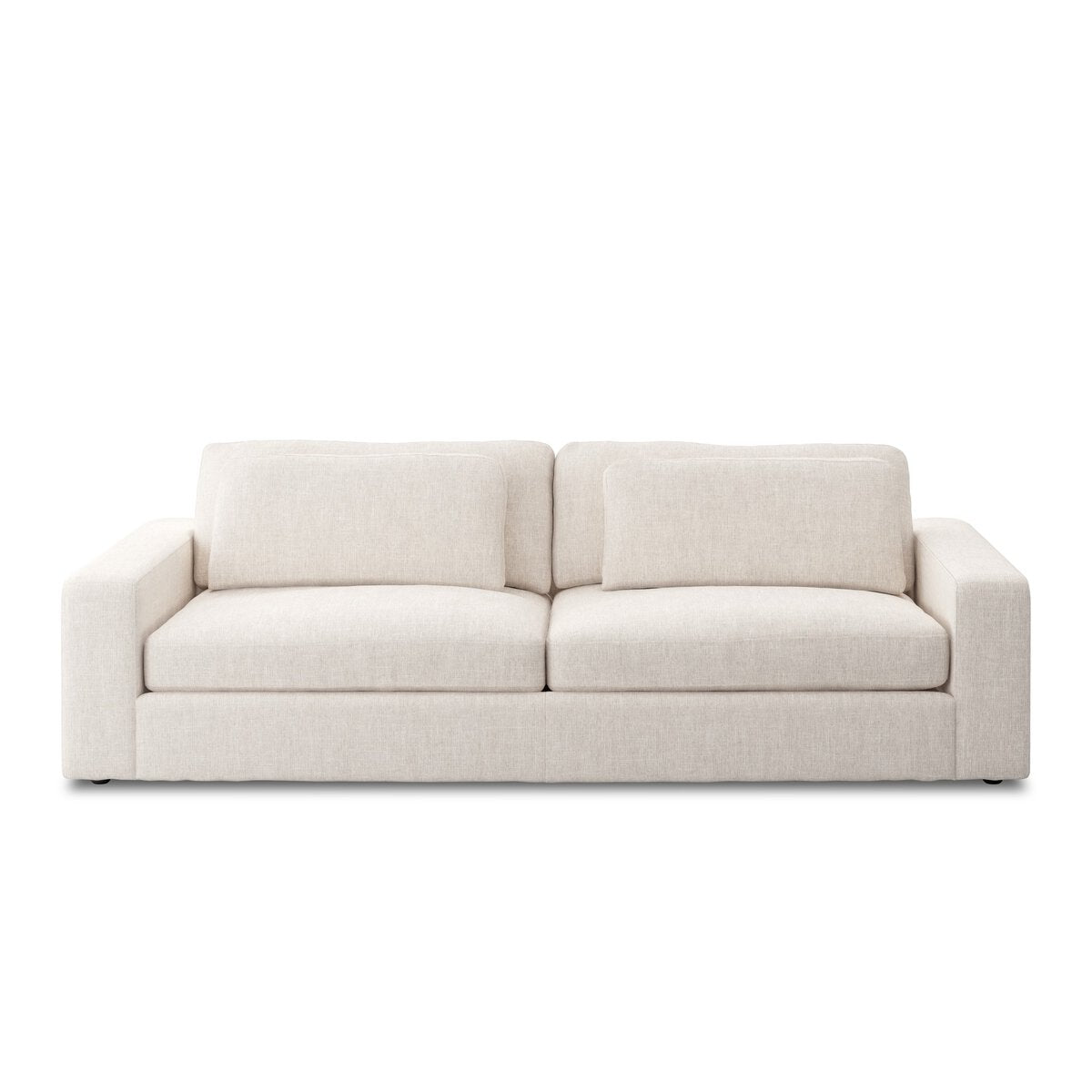 The Modern Low Loveseat, a minimalist beige sofa with thick armrests, two seat cushions, and two back cushions, sits against a plain white background—ideal for those seeking stylish comfort and practical dimensions.