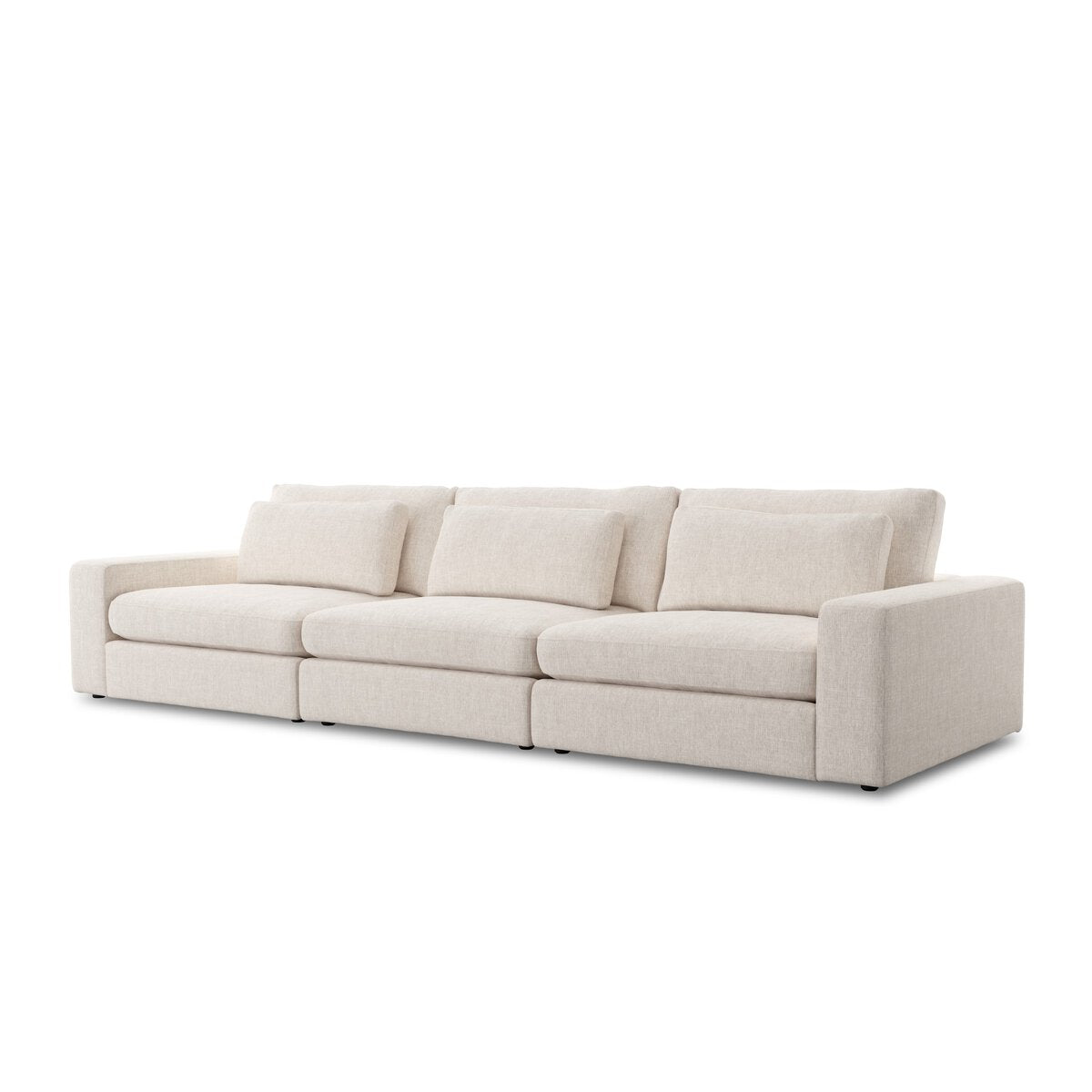 The 3-pc Modern Low Sectional is a contemporary three-seater with light beige fabric, three seat and back cushions, and rectangular armrests. Its clean, minimalist look pairs perfectly with an ottoman for extra comfort.