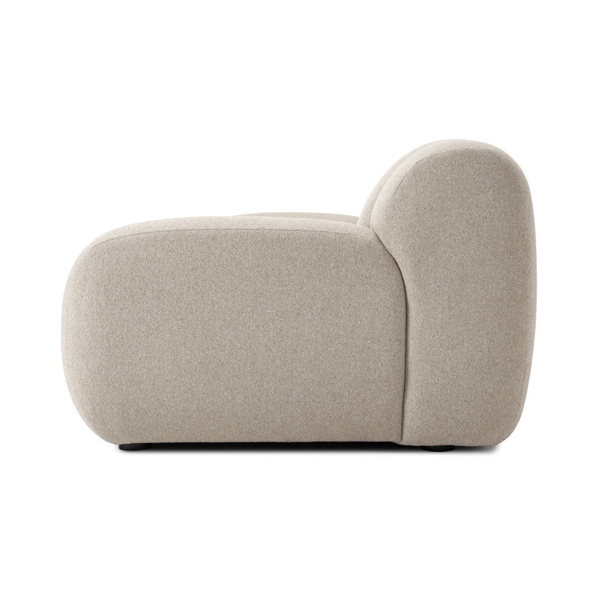 Side view of the Plush Channeled Sofa with soft, rounded edges and light beige upholstery. Its low profile and sculptural form give a cloud-like look, while wide channeling adds to its inviting, modern appeal.