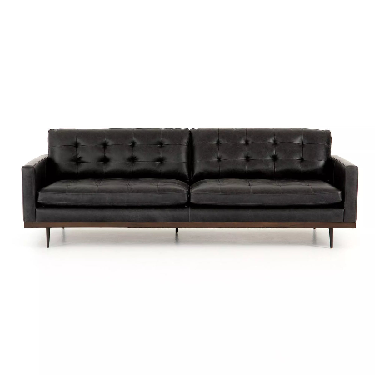 The Lexi Sofa features modern black leather upholstery, tufted back cushions, sleek arms, and slim metal legs. Measuring 89 inches in length, it offers generous seating without overwhelming your space and sits elegantly against a white background.