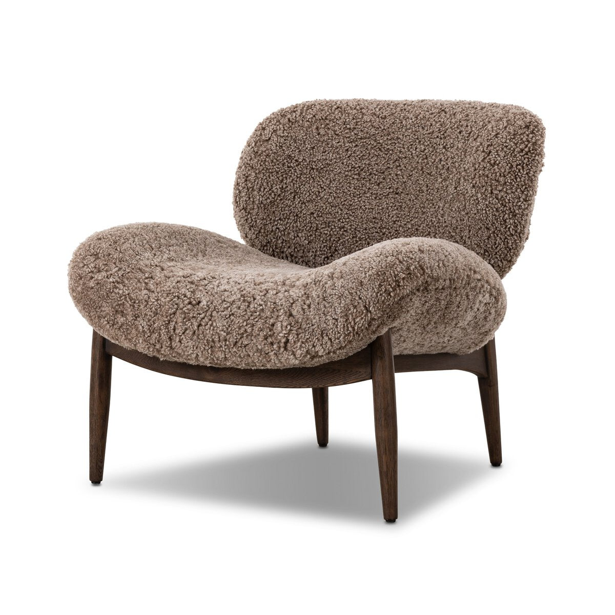 The Shearling Accent Chair features thick, plush brown upholstery, a curved low backrest, and four dark wooden legs. Check the chair's dimensions to ensure it fits your space.