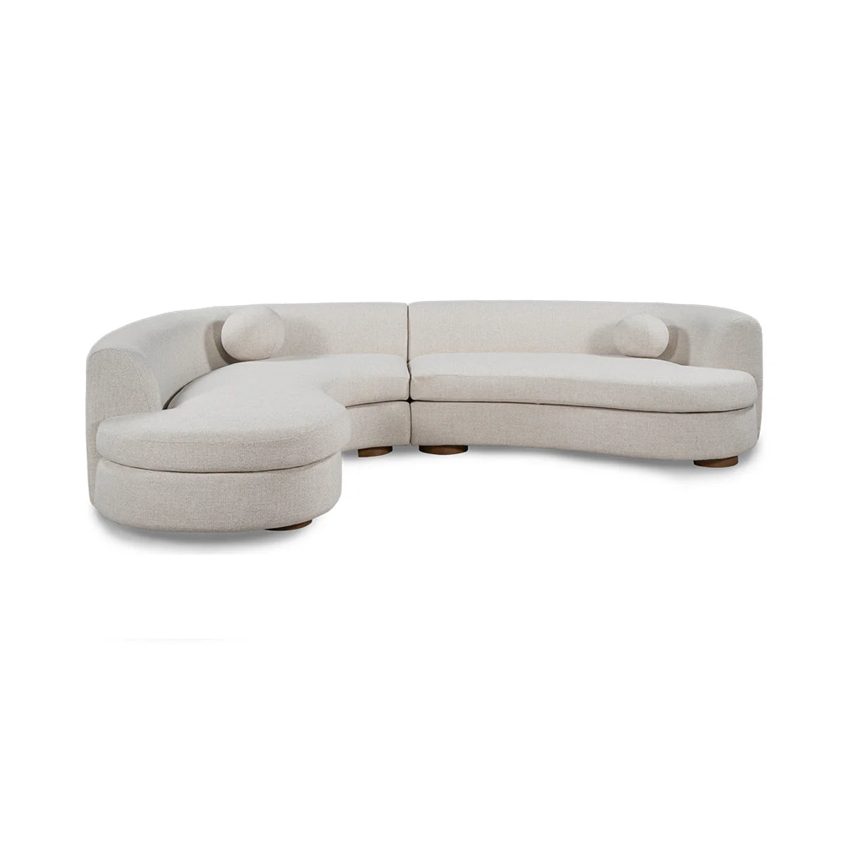 The Curved Upholstered Sectional - Ivory is a modern cream fabric sofa with two round bolster pillows and low rounded wooden legs, offering stylish living room seating against a white background.