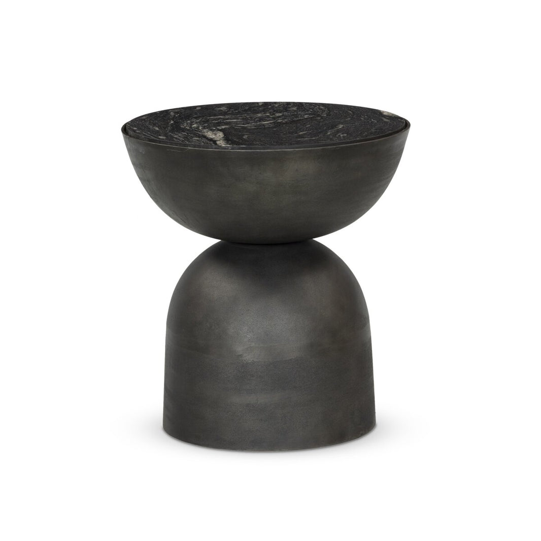 The Aluminum And Marble End Table features a black, sculptural bowl-shaped top and a rounded hammered aluminum base with a matte, stone-like finish, shown against a white background.
