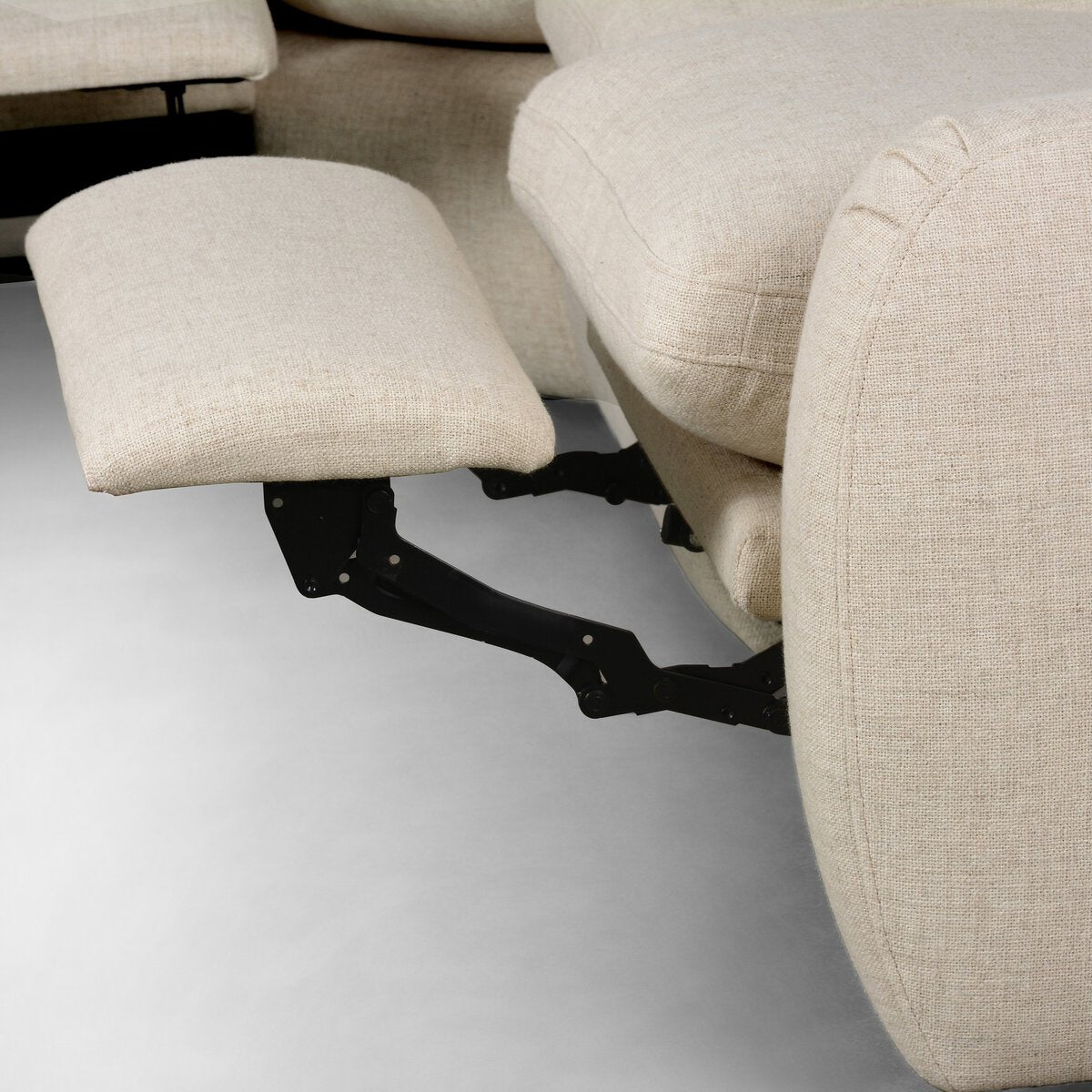 Close-up of Recliner 5pc Sectional in beige fabric with footrest extended, revealing its black metal reclining mechanism—perfect for enhancing your living room or complementing a sectional sofa.