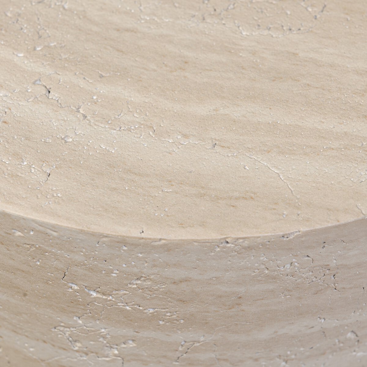 Close-up of the Concrete End Table in Sand, showing its round, light beige surface with subtle cracks and natural texture that emphasize its signature sand finish.