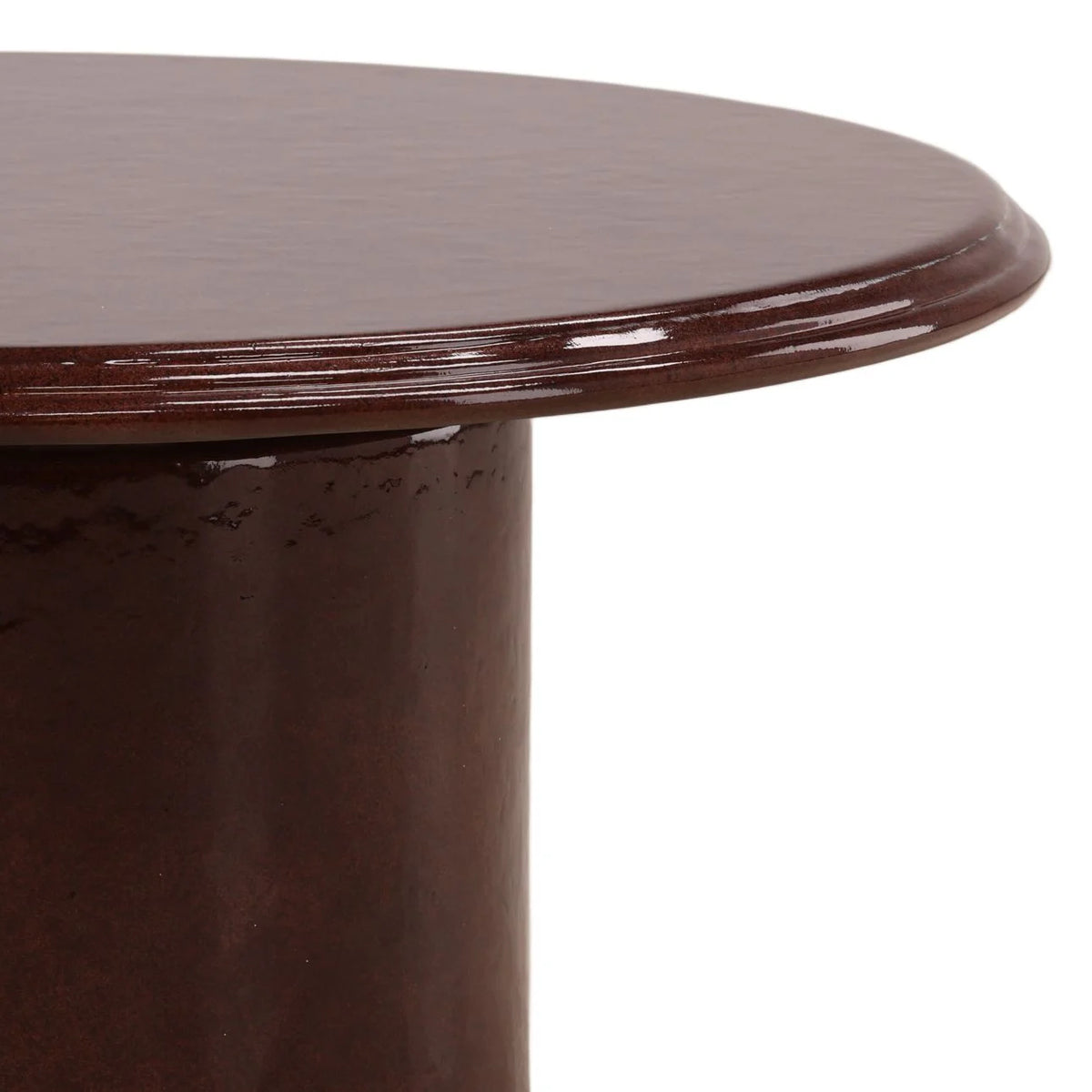 A close-up of the Outdoor Red Concrete Coffee Table, showcasing its round red concrete tabletop and cylindrical base, set against a white background.