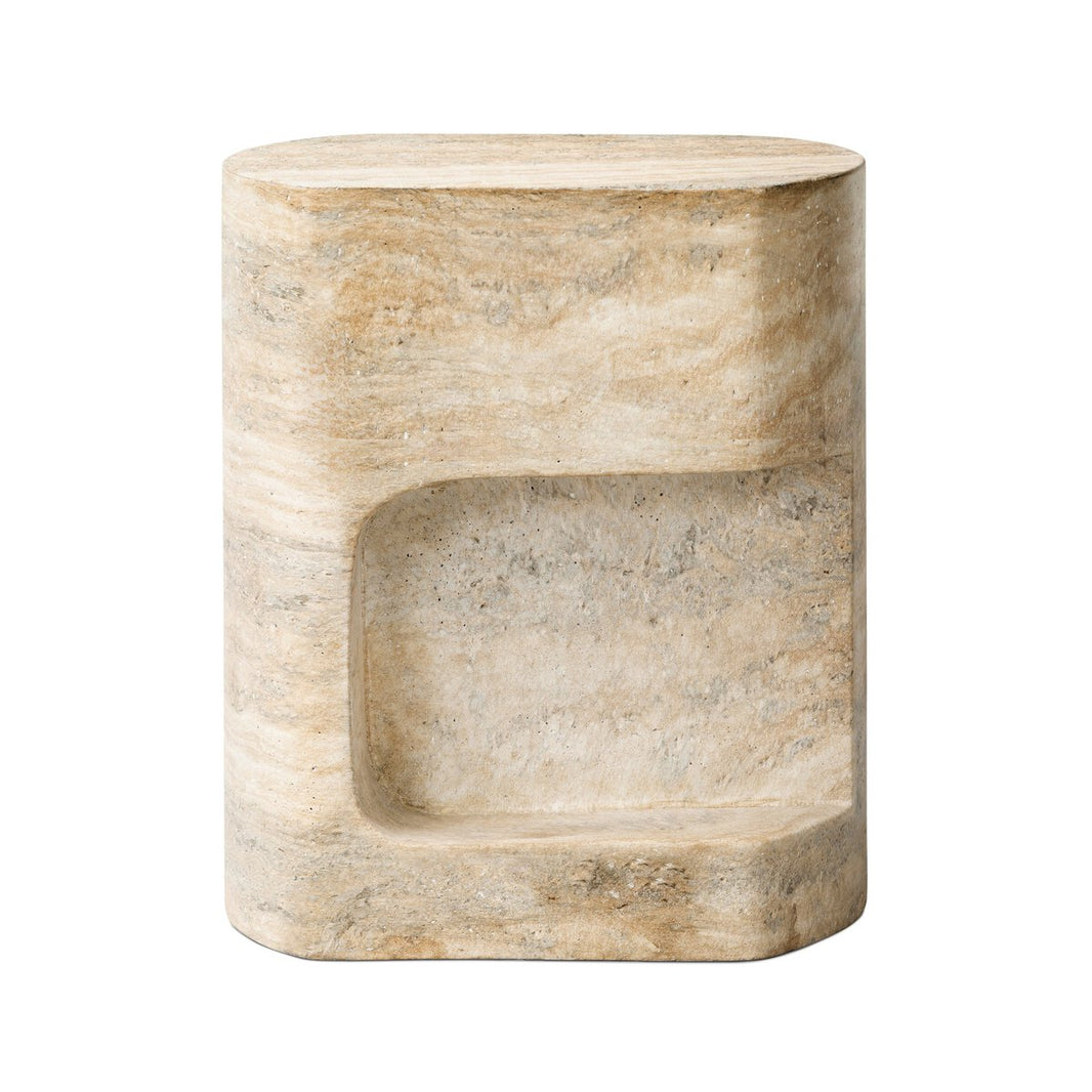 The Textured Concrete End Table is a beige, oval-shaped piece made of stone with a smooth, modern travertine finish. It includes a rectangular shelf on the front for added functionality and style.