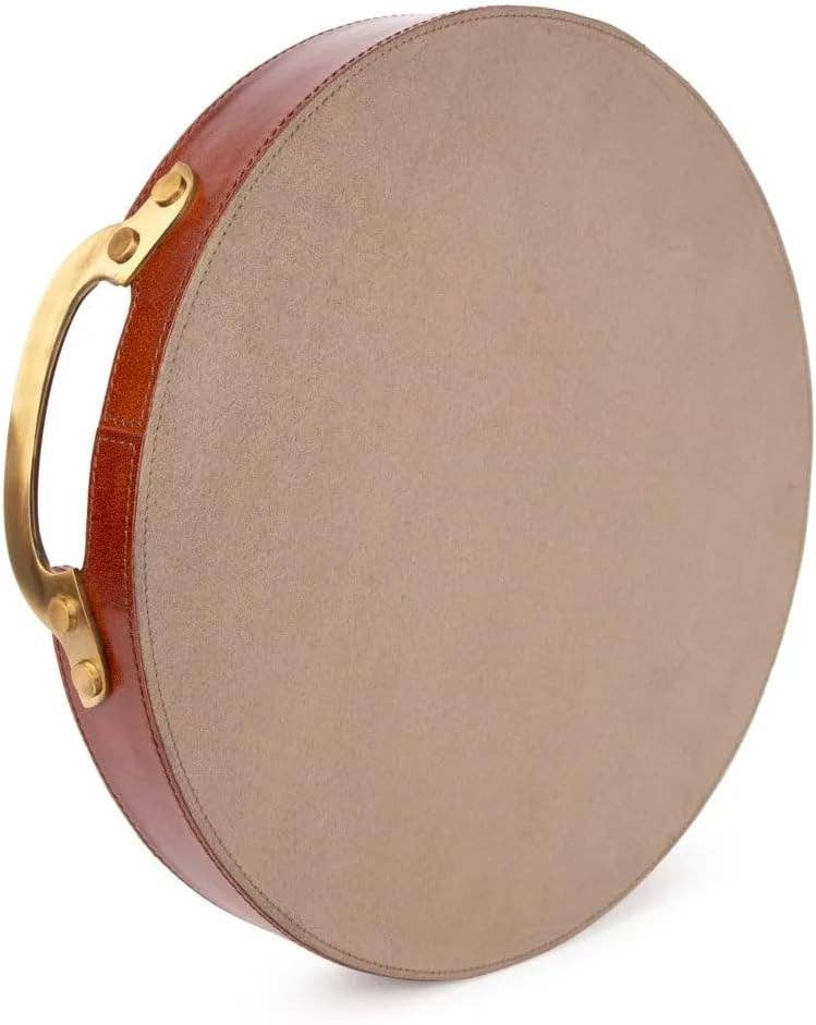 A round, flat tambourine with a beige drumhead, reddish-brown frame, and an attached Vintage Genuine Leather Tray with a brass handle on the side.