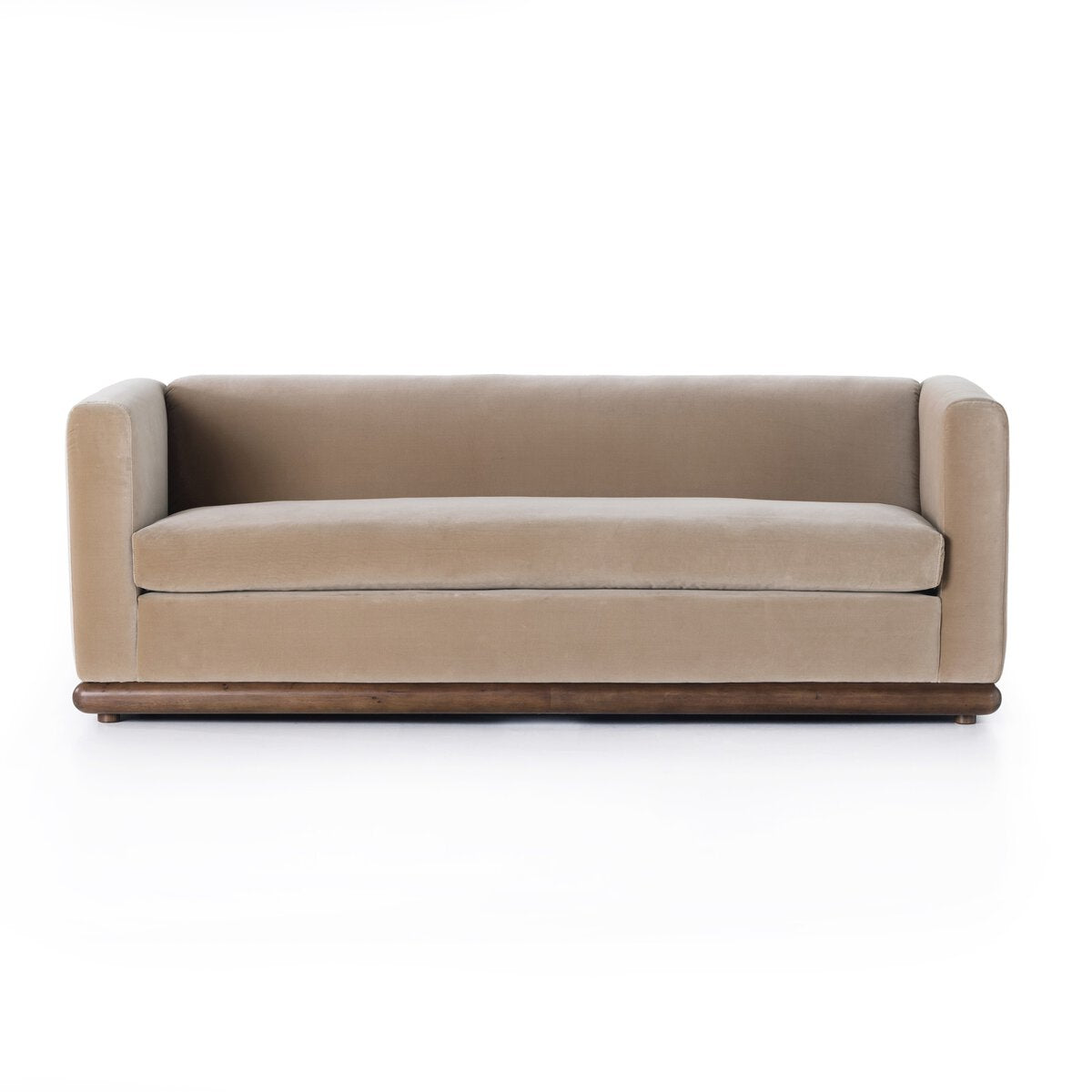 The Deco Sofa features a modern boxy design with straight arms, low back, and parawood plinth base, upholstered in velvety taupe beige fabric, shown against a white background.