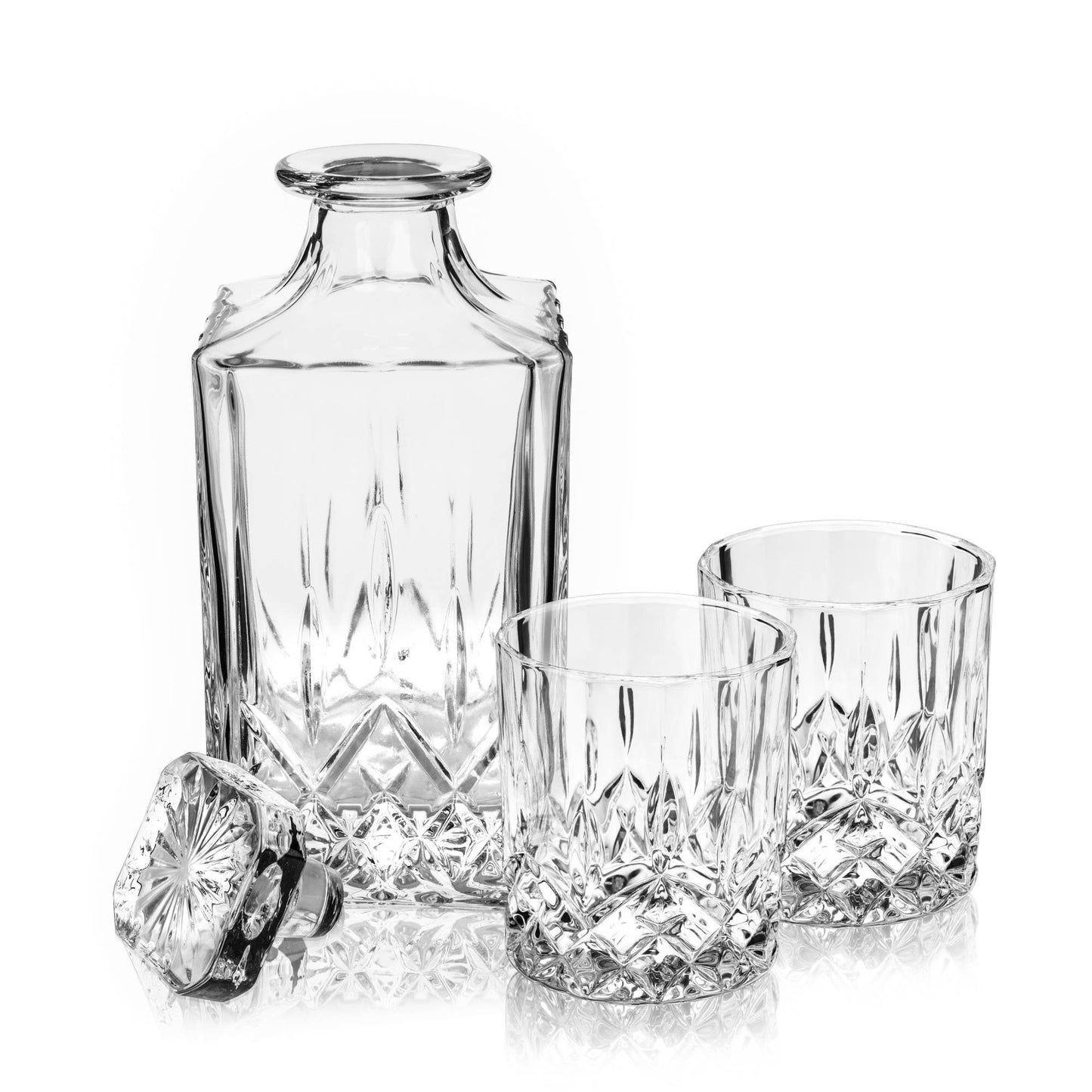 The Crystal Whiskey Decanter and Tumblers (Set of 3) features a lead-free crystal decanter with a matching stopper and two glasses, displayed on a white background with intricate cut-glass patterns and exquisite detailing.