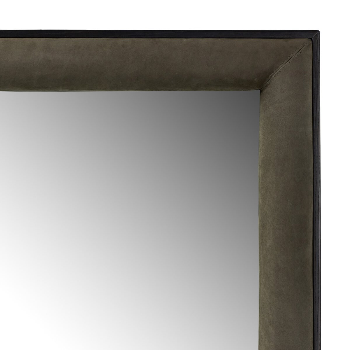 Close-up of the top right corner of the Velaz Floor Mirror, featuring a thick, dark suede-like frame with subtle stitching along the edge. Soft light is reflected in its 42x80-inch rectangular surface.