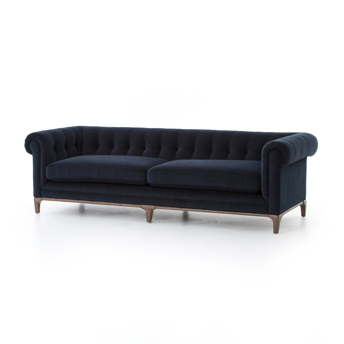 The Chesterfield Navy Sofa, featuring a dark navy blue tufted design with rolled arms, two seat cushions, and wooden legs, sits against a white background, highlighting its elegance and spacious form.
