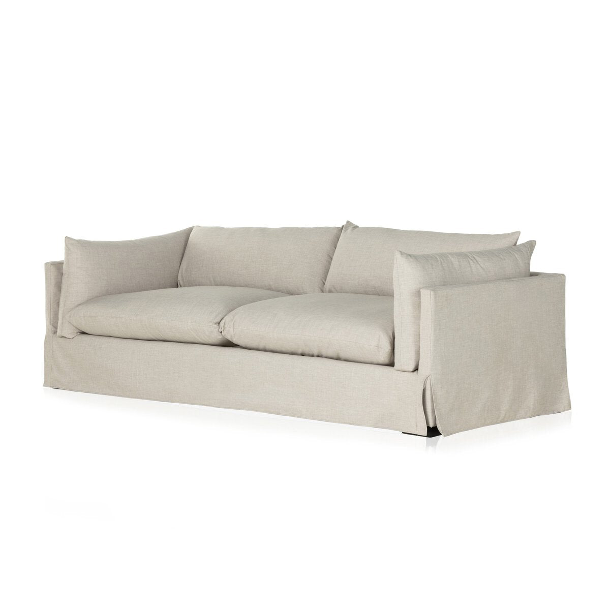 The Slipcover Lounge Sofa is a white couch with pillows, featuring sleek lines and versatile dimensions to fit any living space.