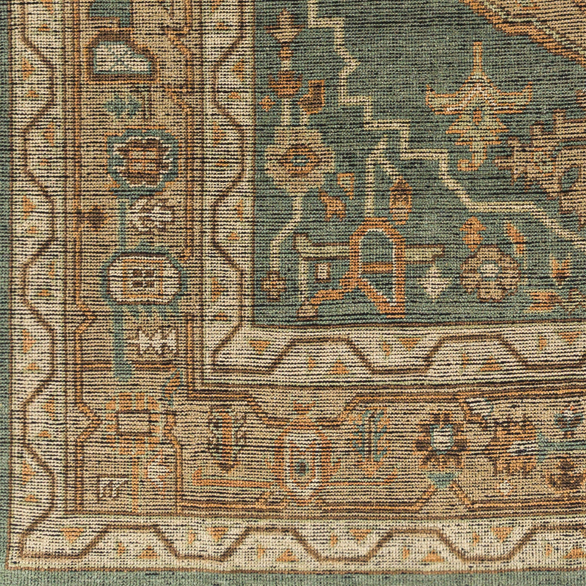 A close-up of the Traditional Dark Green and Beige Rug - 8'x10', showing ornate geometric and floral patterns in green, beige, tan, and rust with a decorative border—available in multiple sizes.