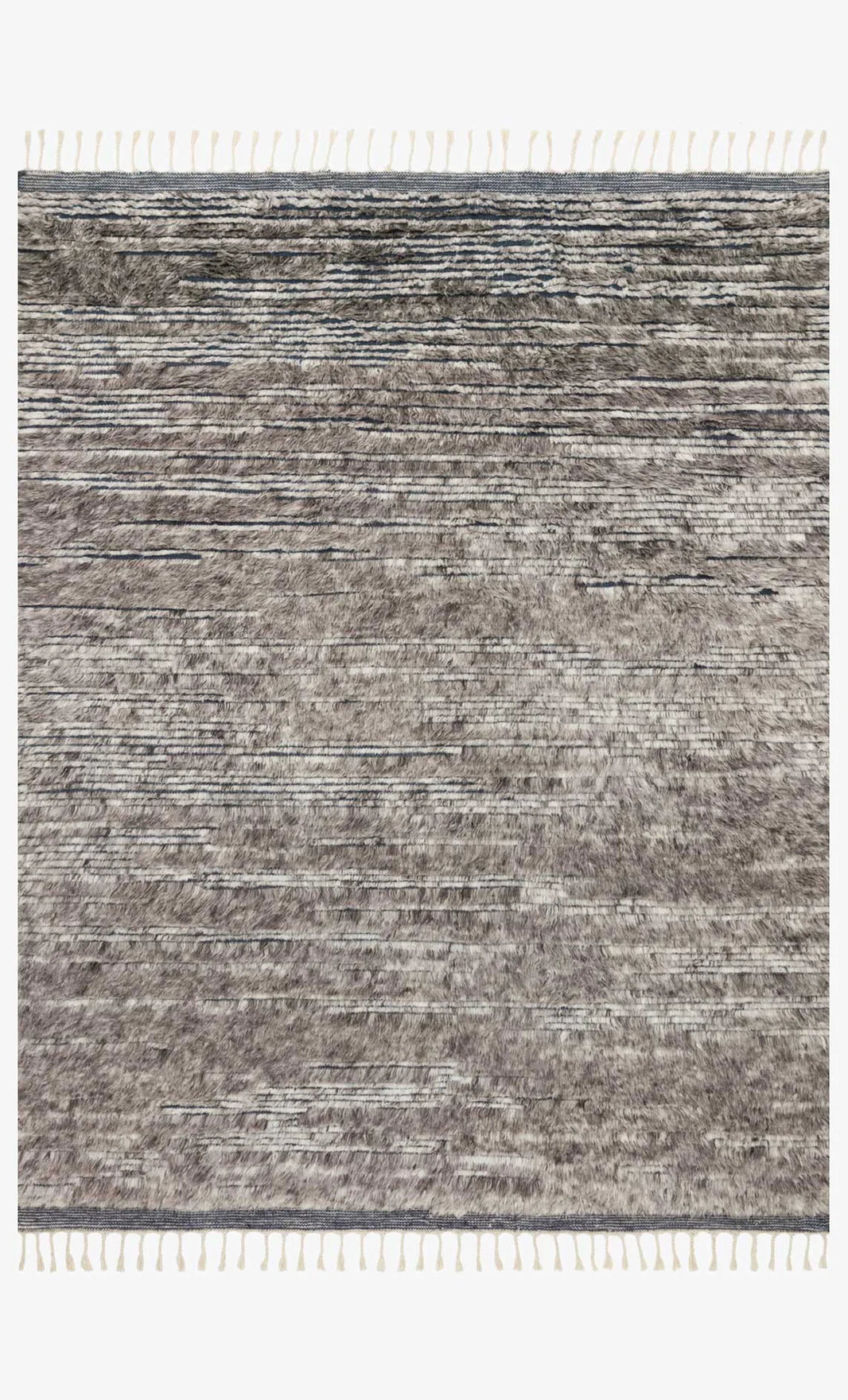 The Indian Wool Rug With Fringes - 8'6x11'6 features a textured, horizontal striped pattern in gray and beige with white fringes on the short edges, available in multiple sizes.