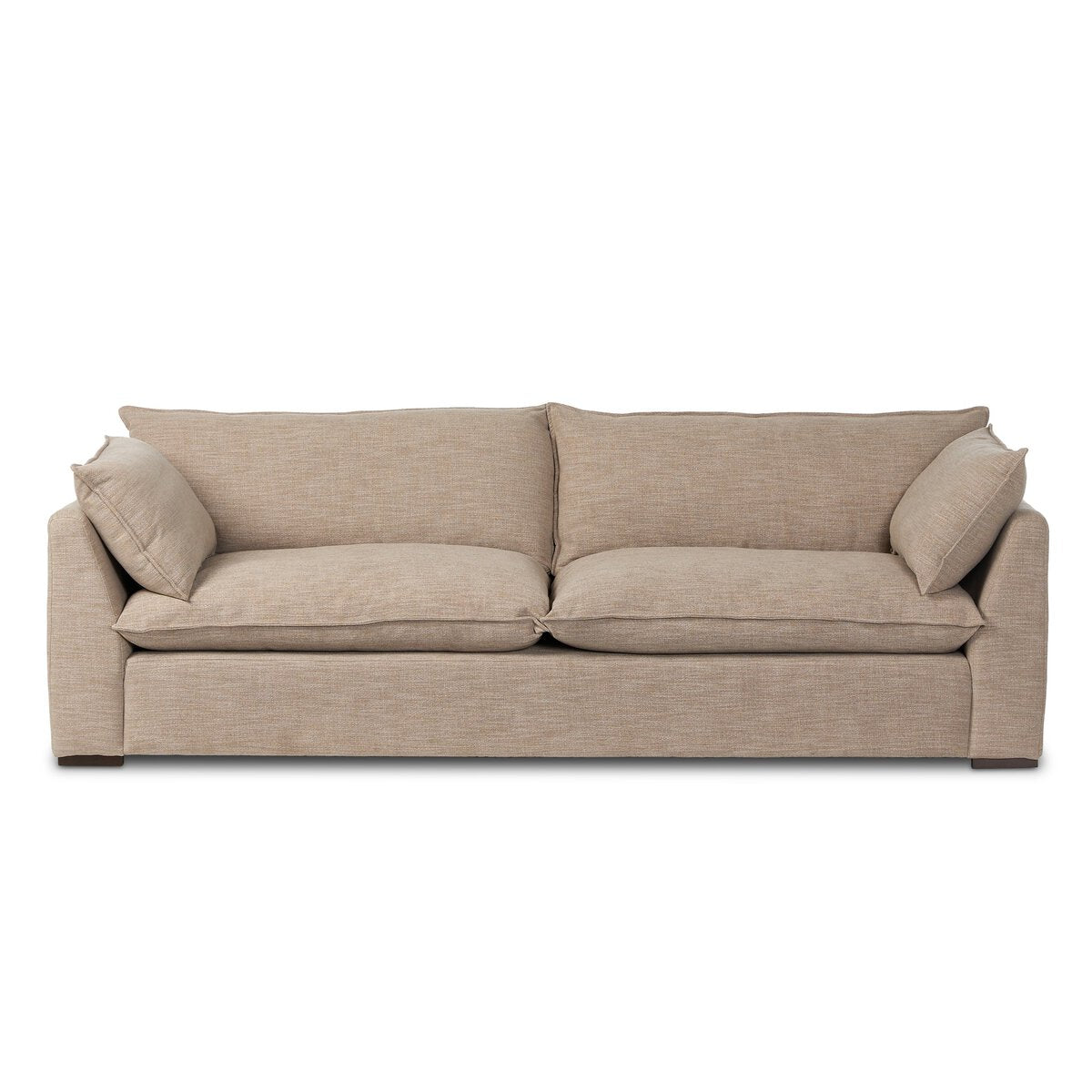 The "Sunken" Sofa is a beige fabric sofa with wide, plush feather-blend cushions, two matching side pillows, low armrests, and wooden block feet for a modern boxy look.