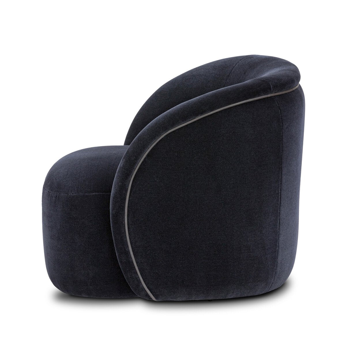 The Low Profile Swivel Chair features a modern, dark velvet finish with a rounded back and seat, curved seamless design, and is shown from the side against a white background.