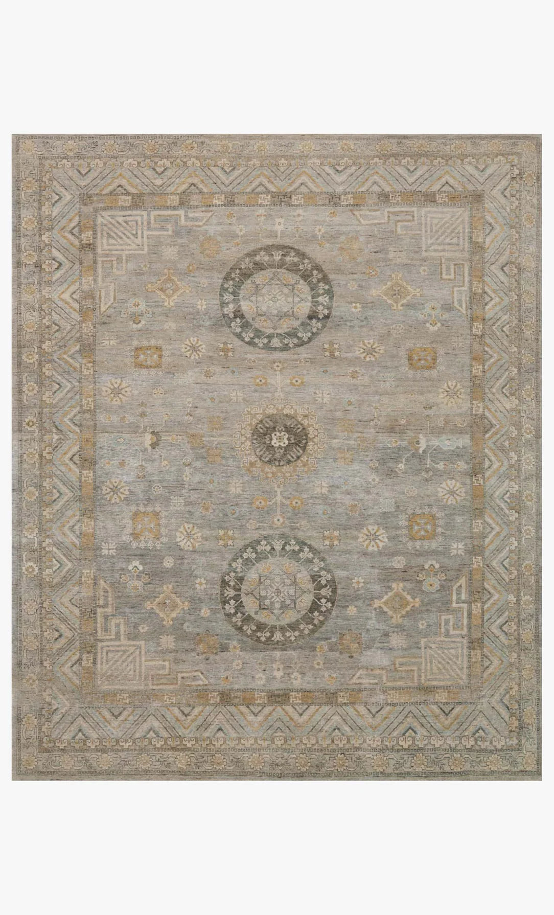 The Hand Knotted Ash Rug 8'x10' features a faded geometric and floral design in muted blue, beige, and gray tones with detailed borders and central medallions, adding elegance to any space. Available in various sizes.