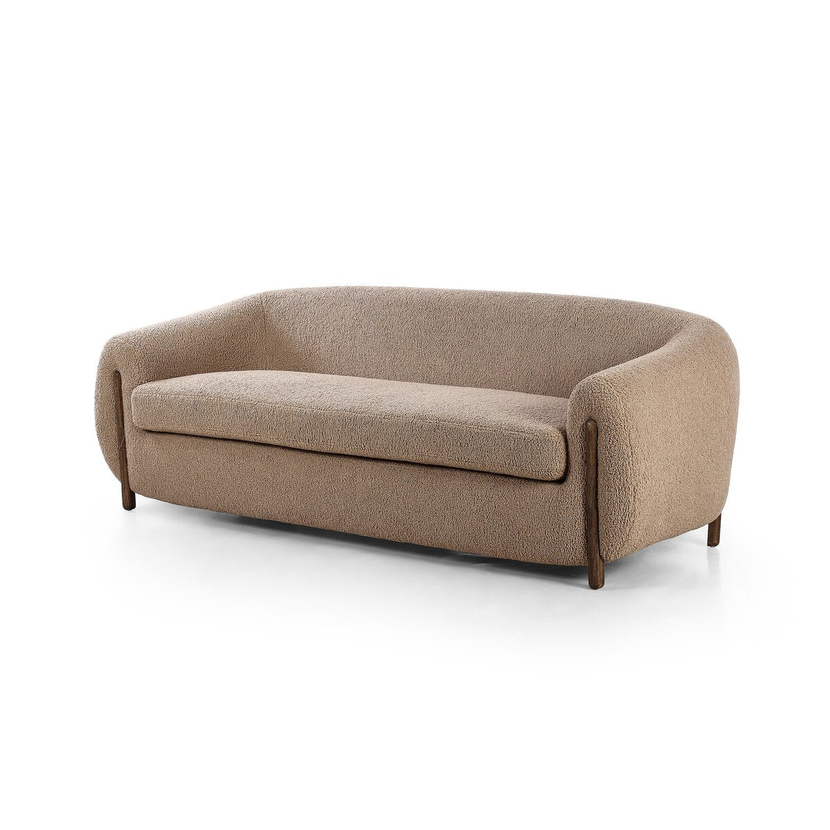 The Tub Loveseat is a modern three-seater with deep seating, soft rounded edges, light brown textured fabric, short wooden legs, and a seamless backrest and armrest design.