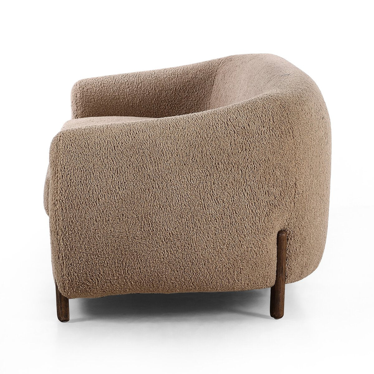 The Tub Loveseat is a modern, light brown seating option with a deep seat, textured fabric upholstery, rounded edges, and wooden legs, displayed from the side against a white background.