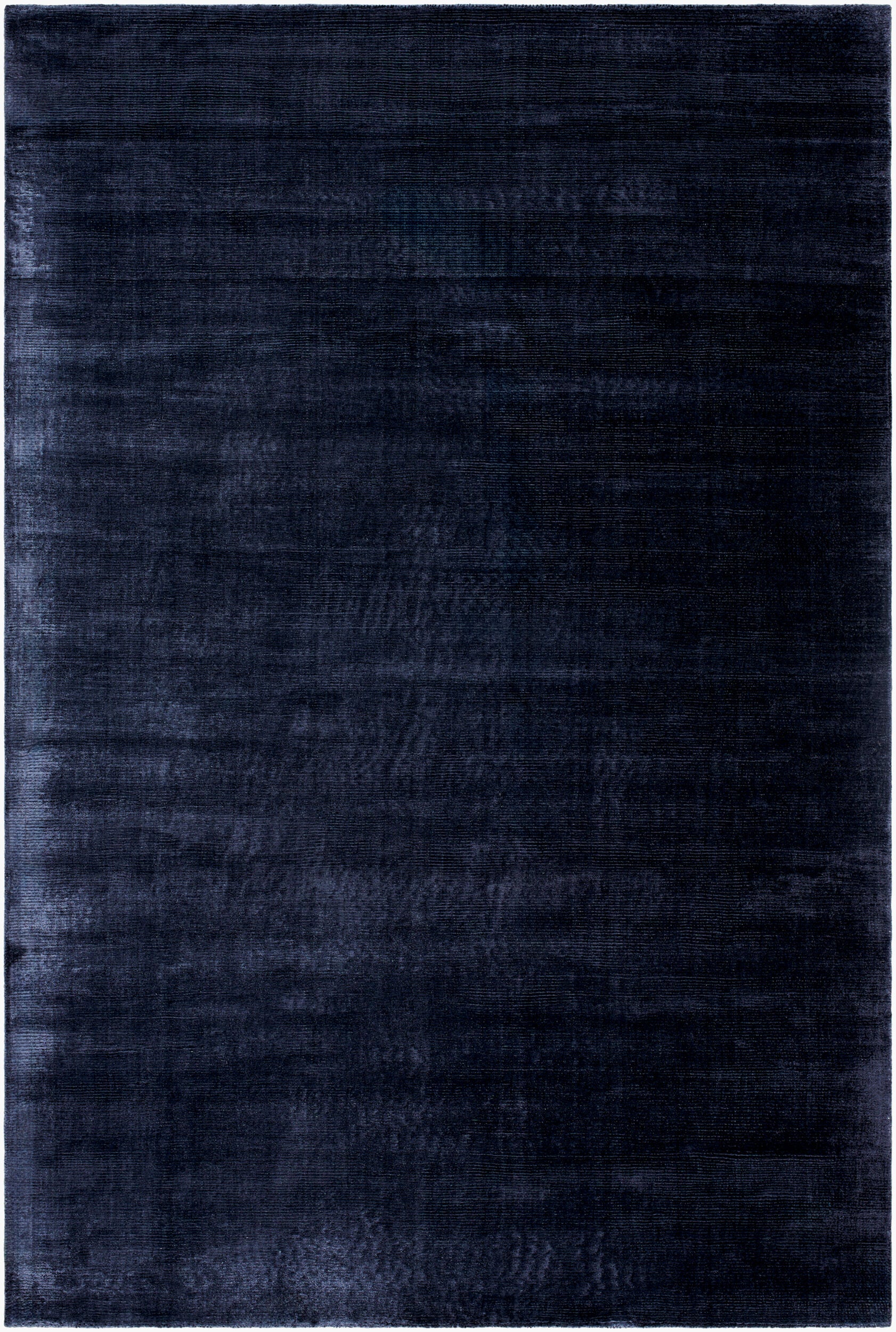 The Striped Cord Rug 8 x 10 features a rectangular, solid dark blue design with a subtle textured pattern and a lighter blue border. Its soft, velvety surface adds depth and richness to any space.