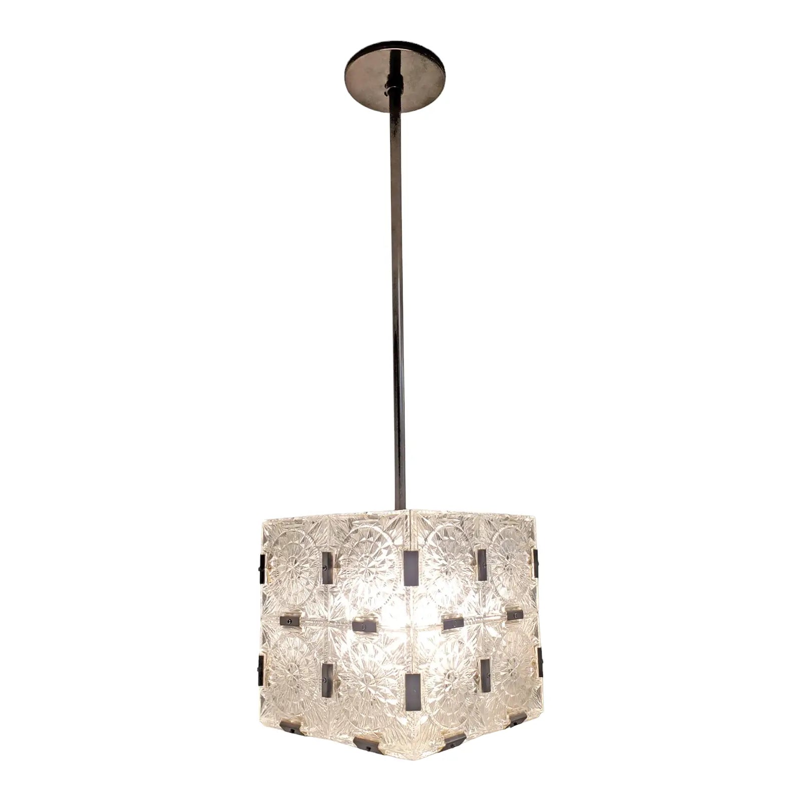 The Mid Century Frosted Glass Light Pendant features a square shade, bringing vintage charm and retro style to any room.