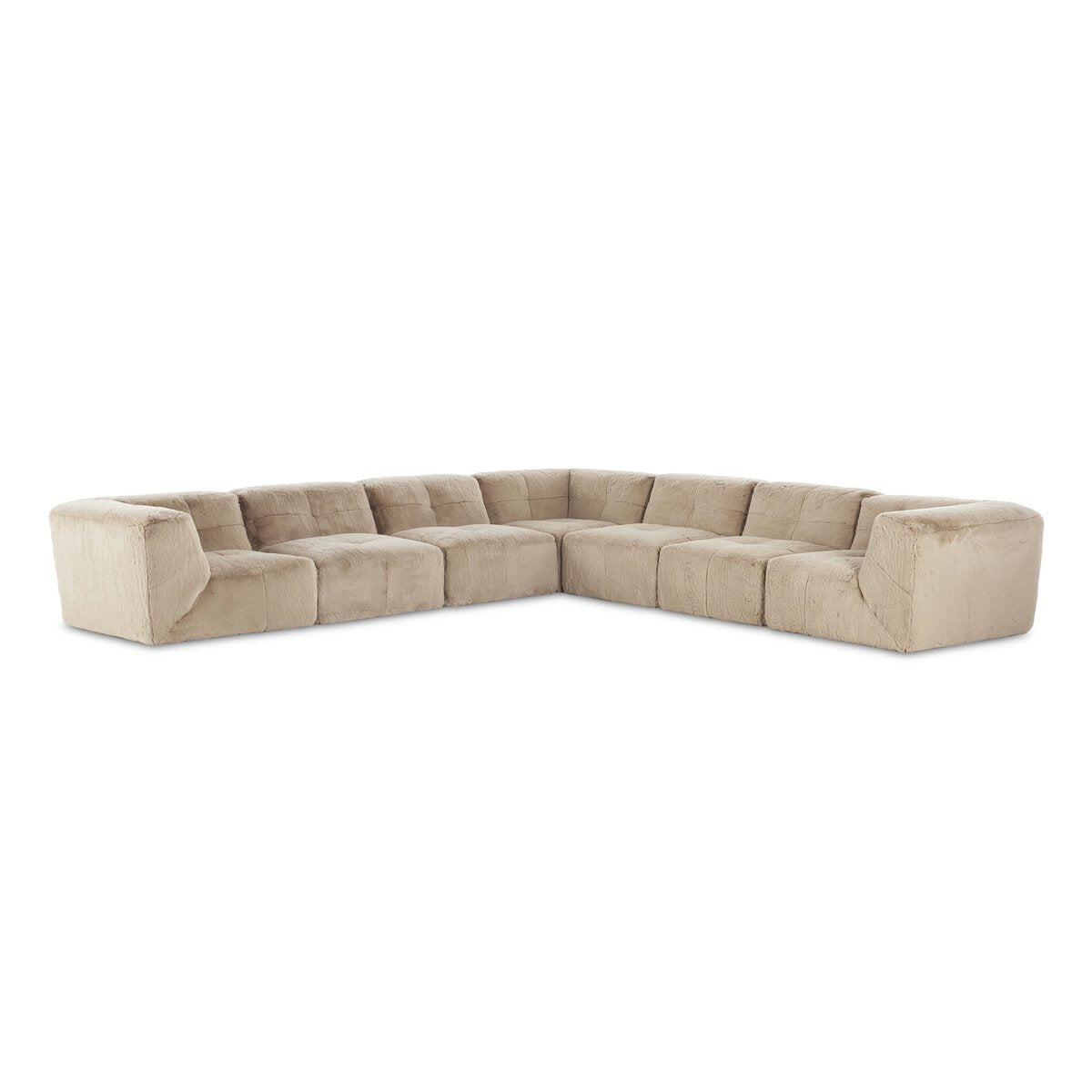 The Plush Sectional - 7pc is a large, beige L-shaped sofa with cushioned seats, S-spring suspension, low backrest, and plush fabric upholstery, shown on a white background.