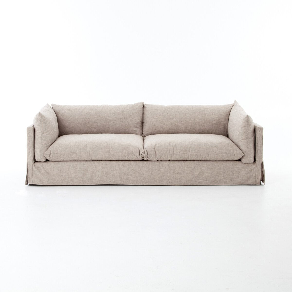 The Slipcover Lounge Sofa is a beige, modern three-seater with plush cushions and low armrests, displayed against a plain white background. Overall dimensions: 96.50"w x 40.00"d x 30.00"h.