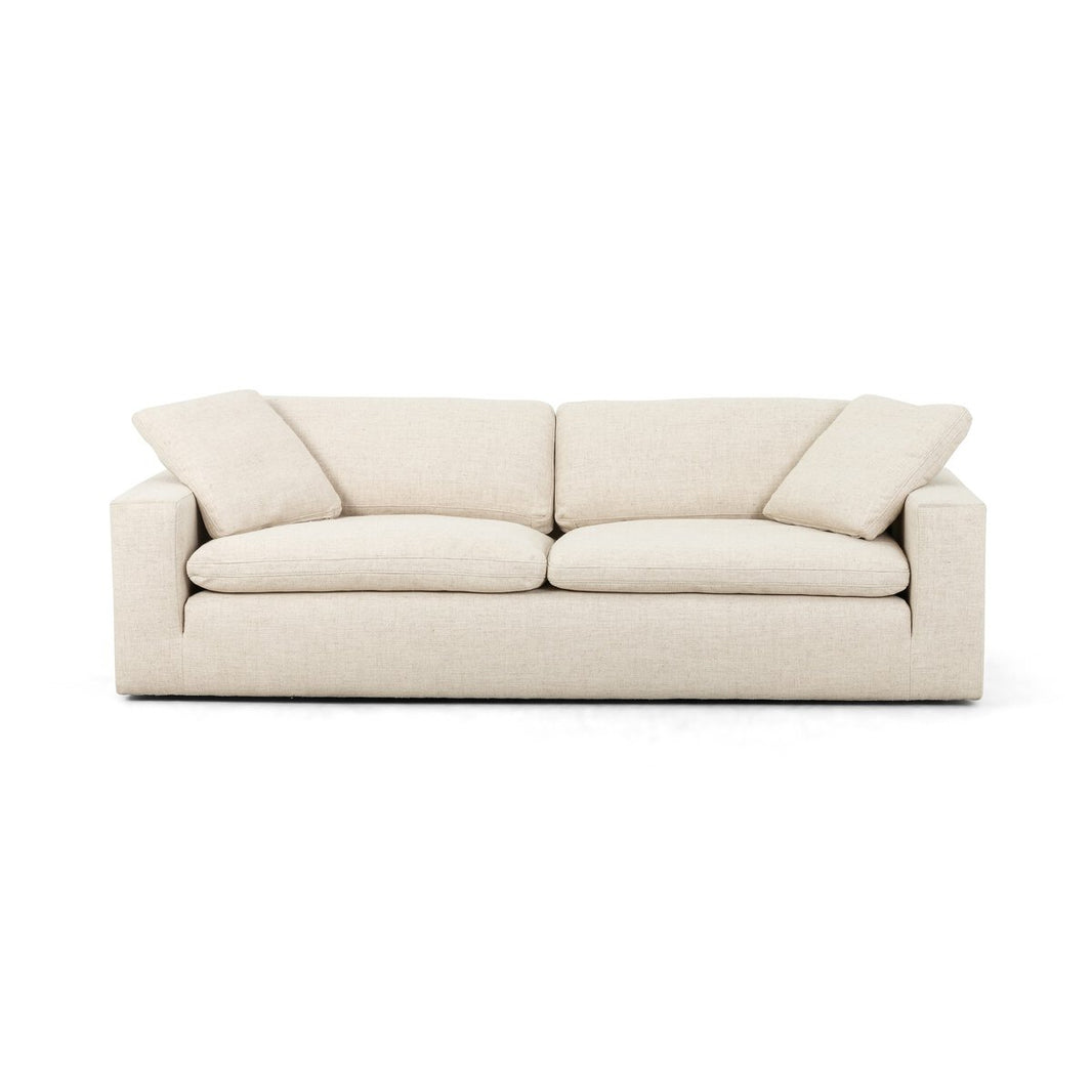 The Performance Cream Sofa features modern design in light beige, with feather-filled cushions and two matching side pillows, all in performance cream upholstery, shown against a white background.