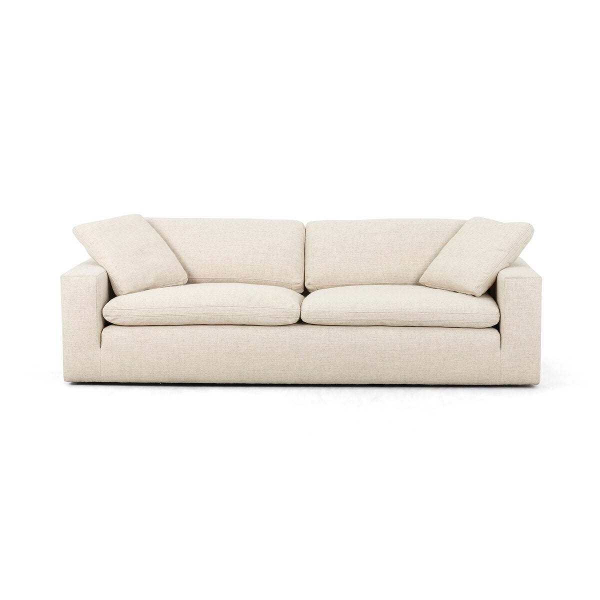 The Performance Cream Sofa features modern design in light beige, with feather-filled cushions and two matching side pillows, all in performance cream upholstery, shown against a white background.