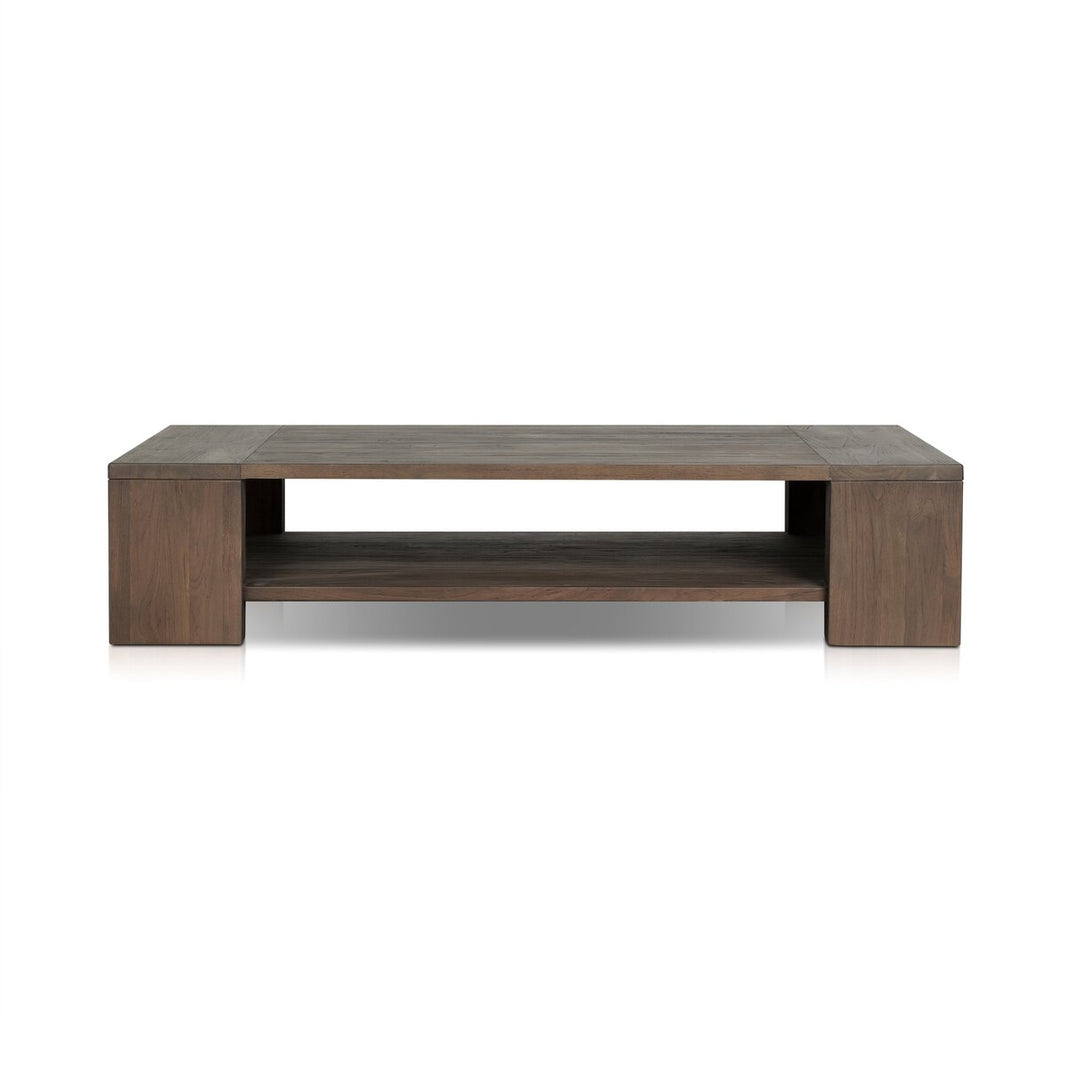 The Outdoor Chunky Rectangle Coffee Table is crafted from reclaimed teak wood with a dark brown finish, featuring a low, wide profile and an open shelf beneath the tabletop for extra storage.