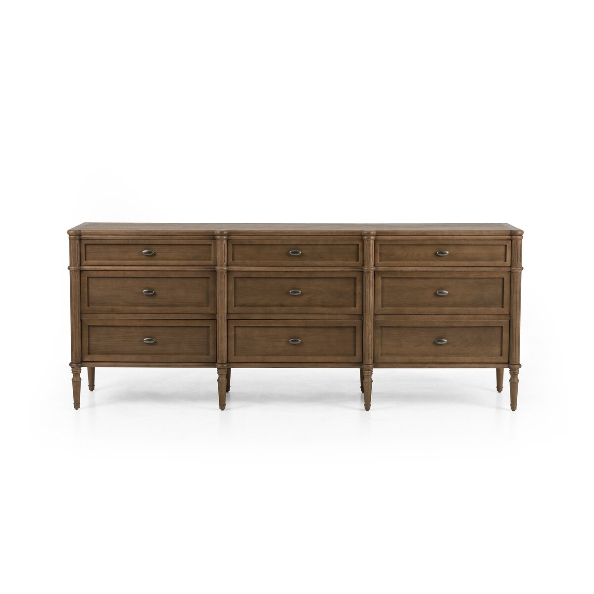 The European 9 Drawer Dresser features a toasted oak finish, round metal knobs, and slender, tapered legs. Its classic look complements modern bedrooms, as shown here against a plain white background.