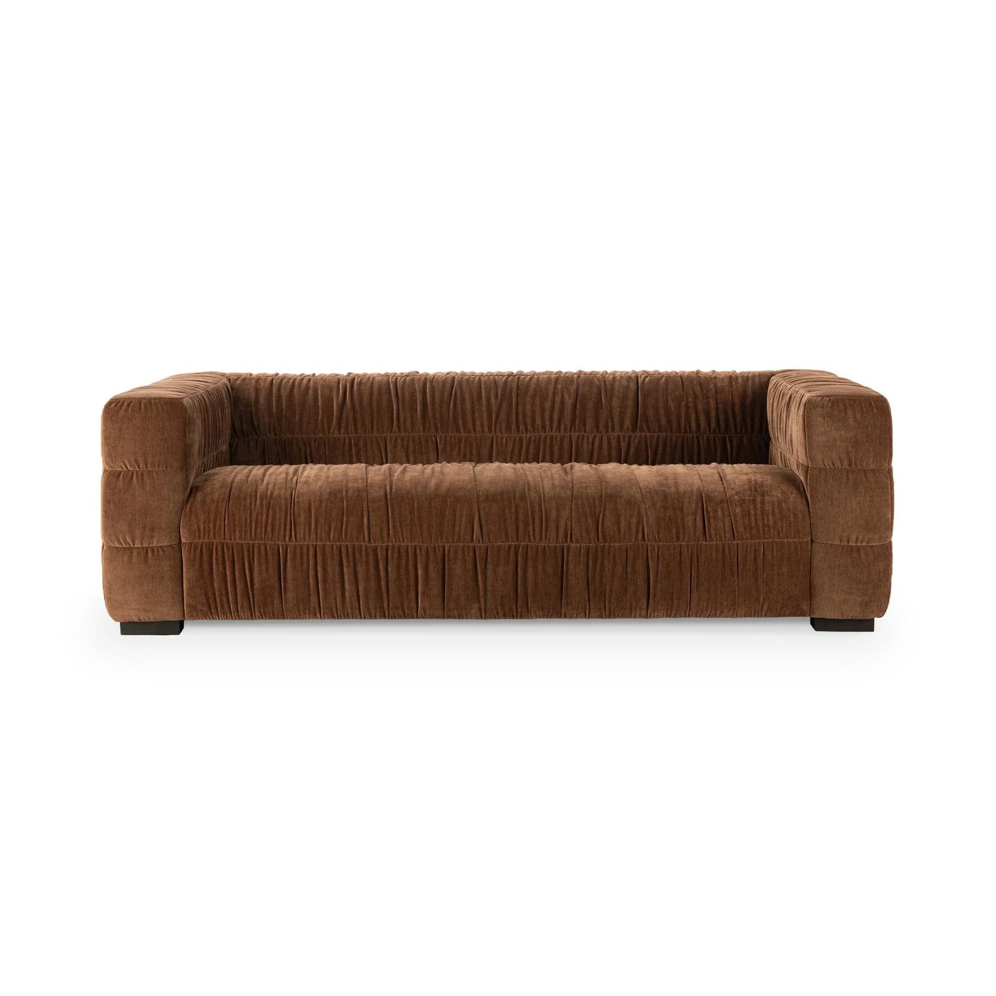 The Ruched Upholstered Sofa features wide blocky arms, a low backrest, and pleated brown upholstery that highlights modern luxury and artistry, set against a plain white background.