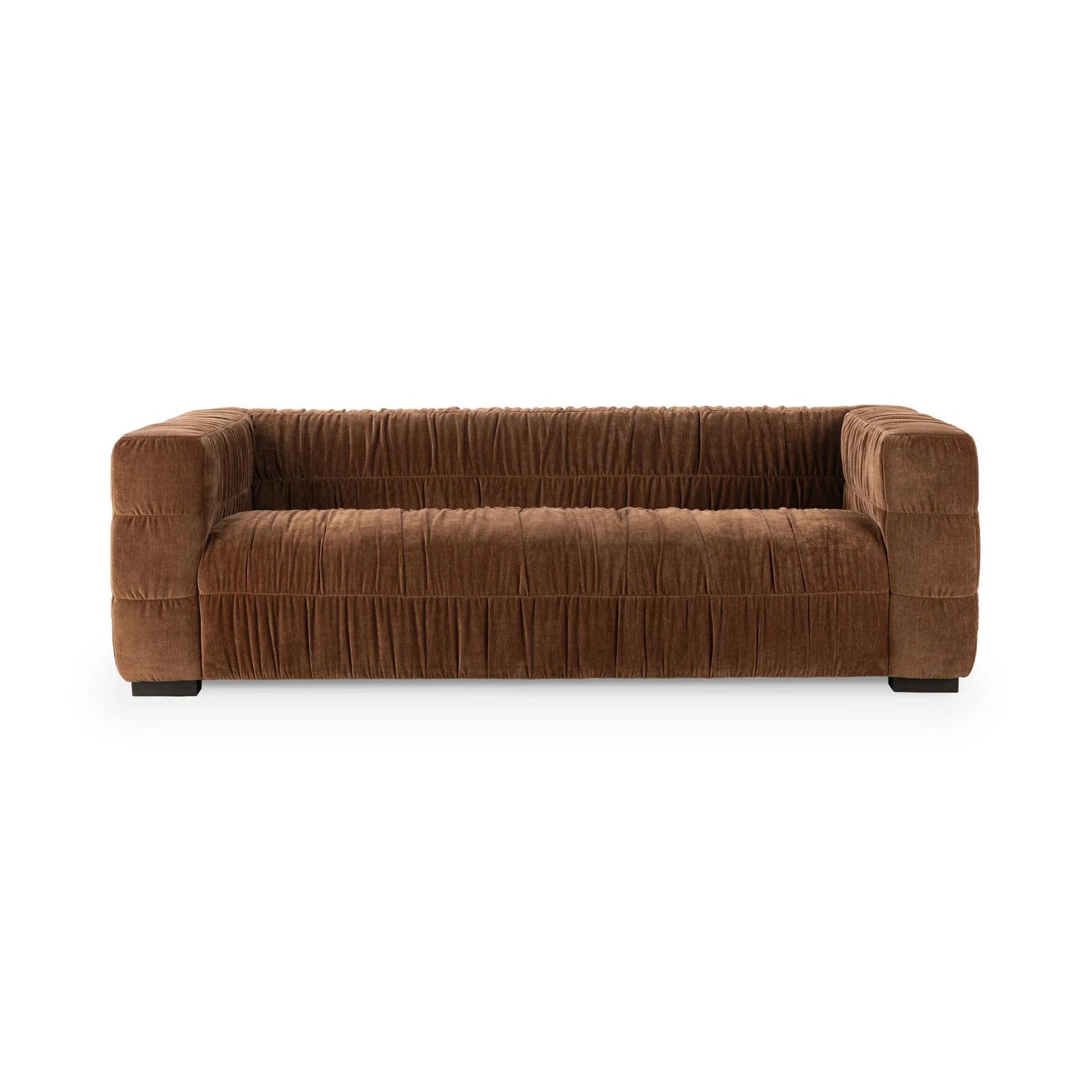 The Ruched Upholstered Sofa features wide blocky arms, a low backrest, and pleated brown upholstery that highlights modern luxury and artistry, set against a plain white background.