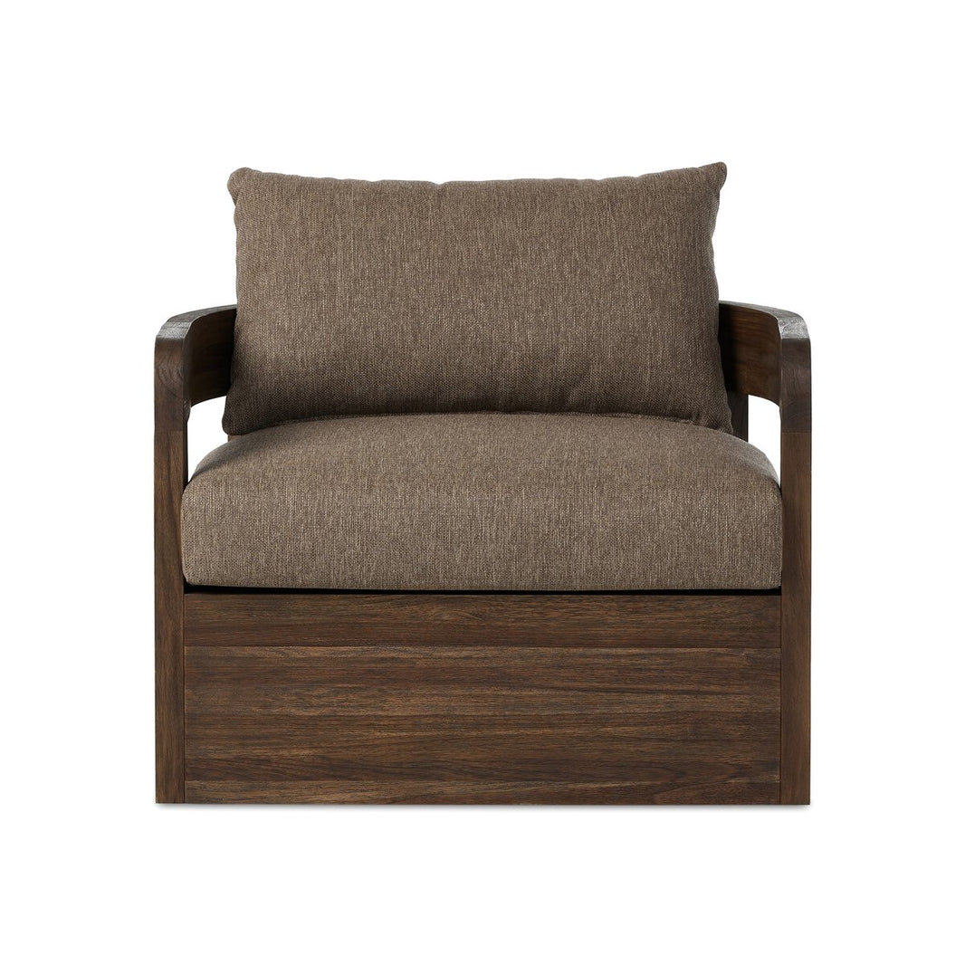 The Outdoor Swivel Chair features a dark wood frame, light brown cushions, wide wooden armrests, and a boxy minimalist design, similar to a modern teak chair. The image shows the chair on a plain white background.