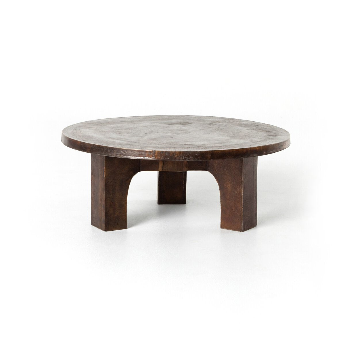 The Brutalist Coffee Table features a round, dark wood design with a thick top and four wide, sturdy legs in a brutalist-inspired style, shown against a plain white background.