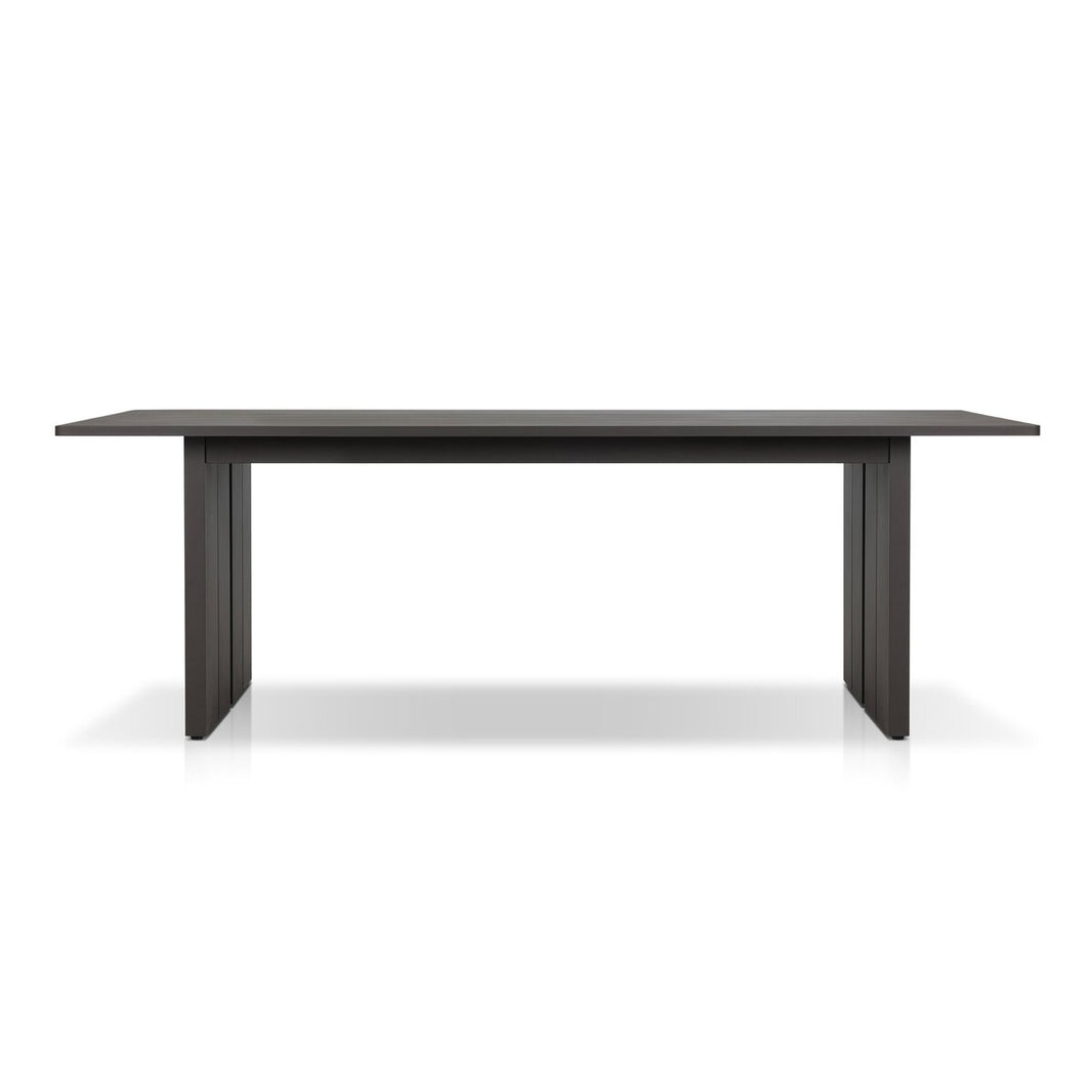 The Outdoor Metal Dining Table is a modern rectangular table with clean lines, a sturdy metal frame, and thick legs. It seats eight comfortably and is shown against a white background.