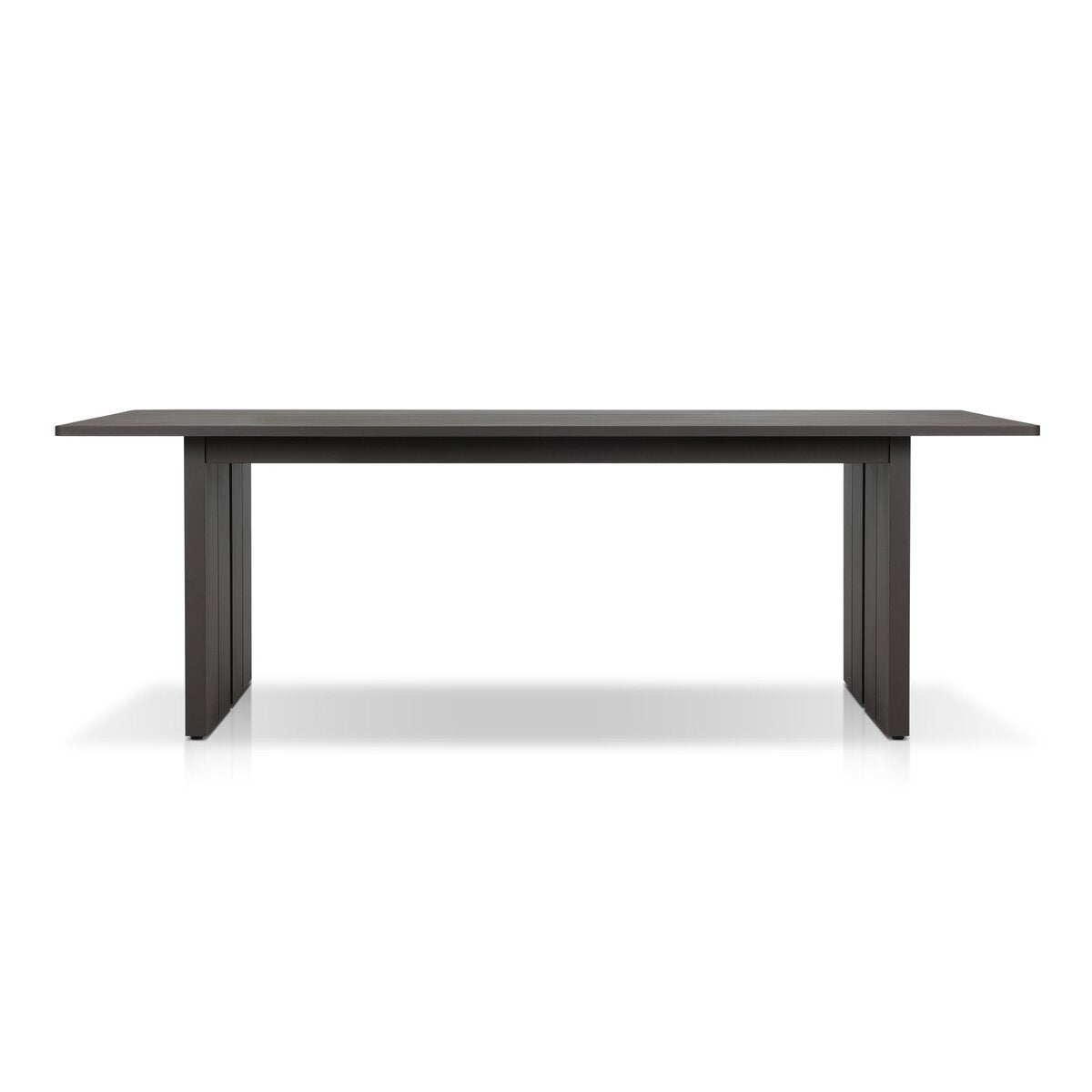 The Outdoor Metal Dining Table is a modern rectangular table with clean lines, a sturdy metal frame, and thick legs. It seats eight comfortably and is shown against a white background.