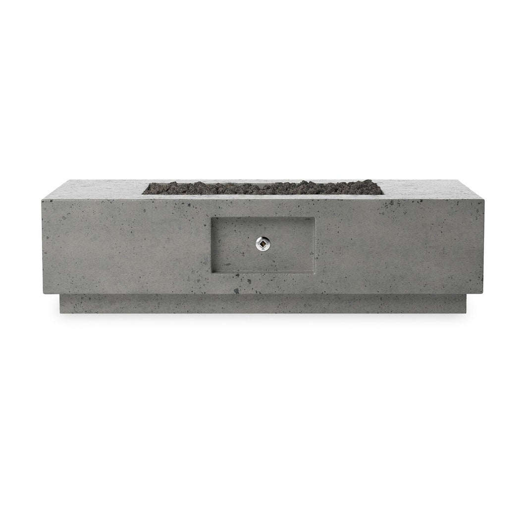 The Outdoor Fire Table, made of glass-reinforced concrete, features a central recessed ignition control panel and a top filled with black lavastones.