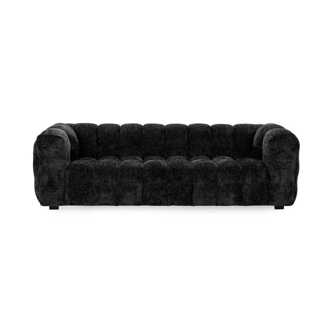 The Upholstered Sofa features black tufted velvet, tuxedo arms, and a low back, all set against a plain white background.