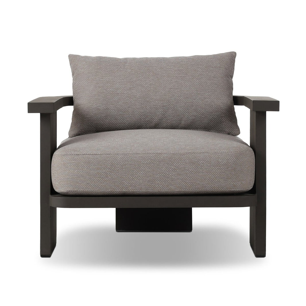 The Three Legged Outdoor Chair features wide, flat black arms and legs, thick light gray high-performance fabric cushions for the seat and back, all shown against a white background.