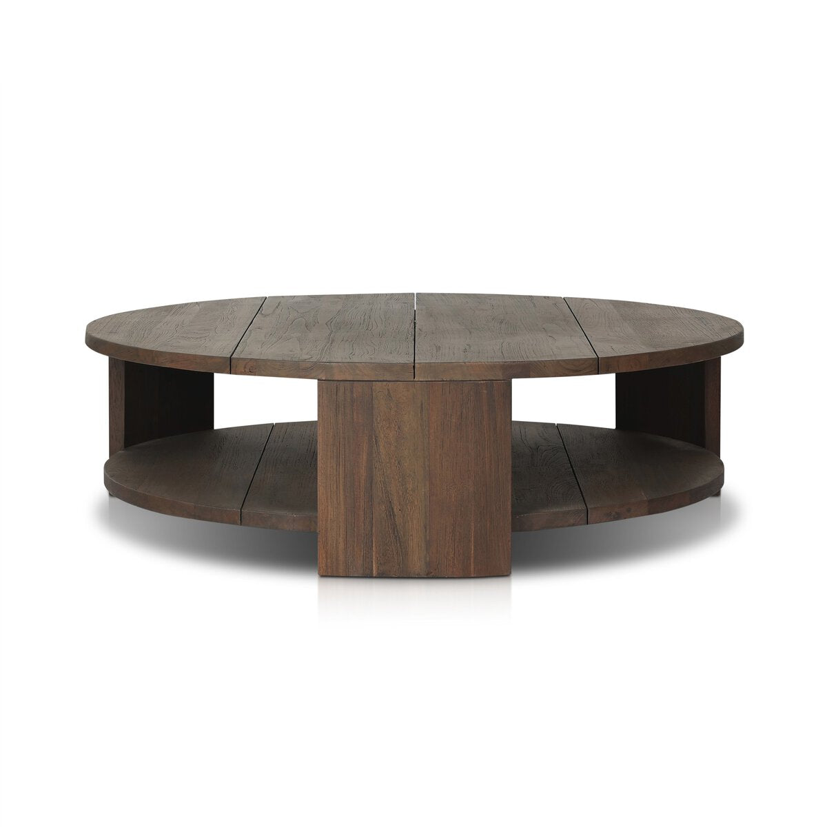 The Outdoor Chunky Round Coffee Table features a thick reclaimed wood top, wide vertical leg panels, a dark finish, and a lower storage shelf.