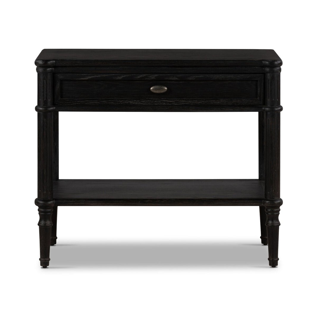 The European Nightstand boasts a smooth matte black finish, one drawer with a round handle, an open lower shelf, and four tapered legs. Its simple, classic design adds timeless style to any bedroom.