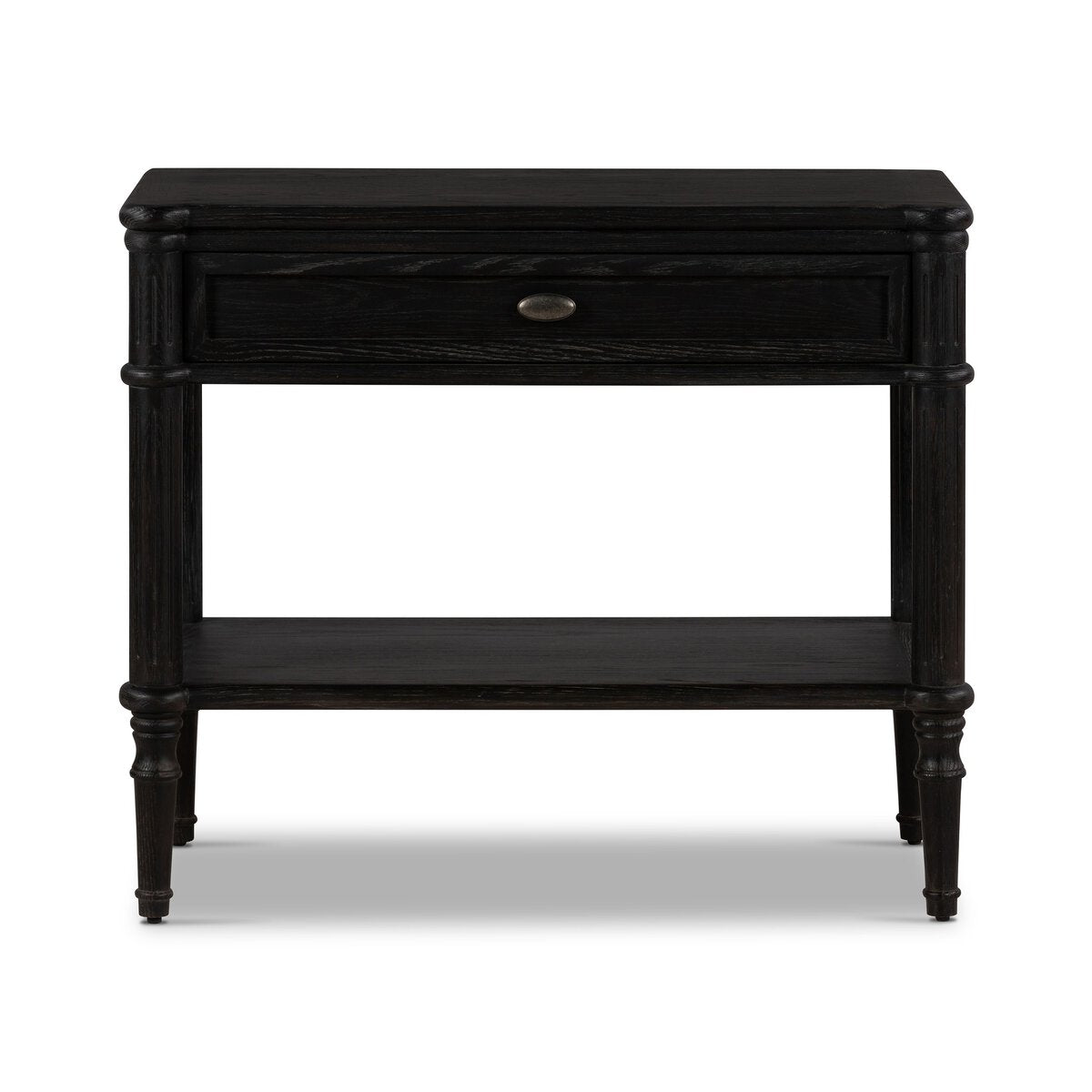 The European Nightstand boasts a smooth matte black finish, one drawer with a round handle, an open lower shelf, and four tapered legs. Its simple, classic design adds timeless style to any bedroom.
