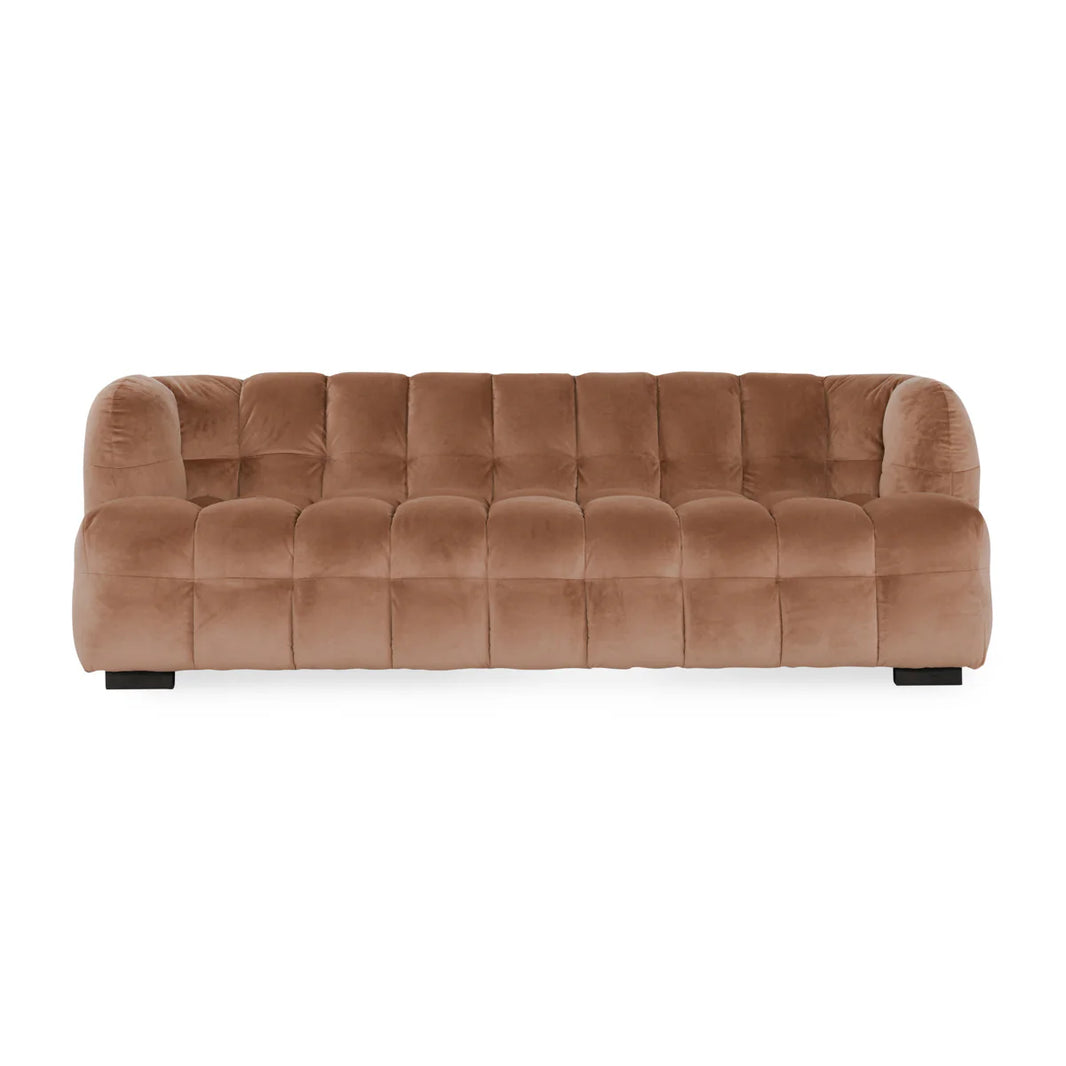 The Velvet Sofa features plush light brown polyester upholstery, biscuit tufting, rounded arms and backrest, and sturdy black block legs for a modern look.