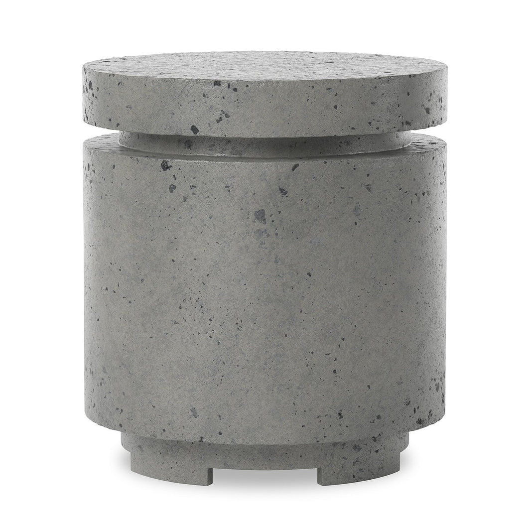 The Outdoor Round Propane Enclosure features a gray, speckled concrete finish, a cylindrical shape with a wider top and narrow groove, and sits on four short feet—ideal as an outdoor end table or fire table accessory for a modern, industrial look.