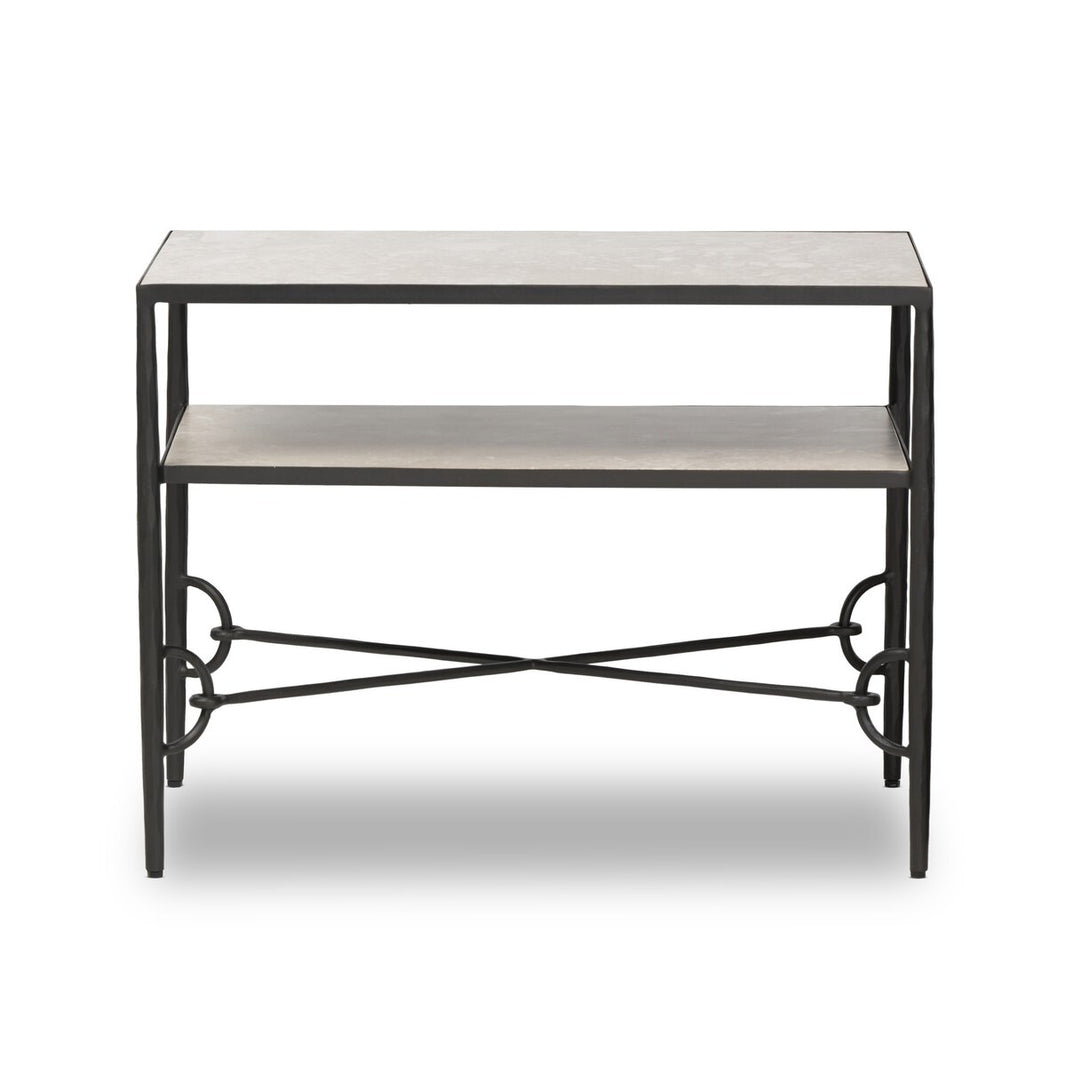 The Hammered Gunmetal Nightstand is a modern rectangular table with a dark metal frame, one open shelf below the tabletop, and decorative circular and X-shaped metal accents connecting the legs.