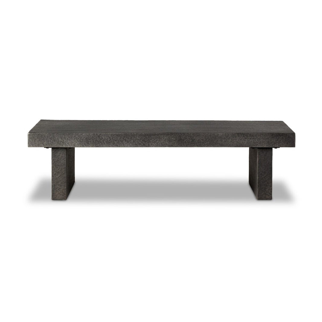 The Distressed Coffee Table is a minimalist, rectangular dark gray bench with a solid flat top and two block-style legs, resembling concrete, displayed against a white background.